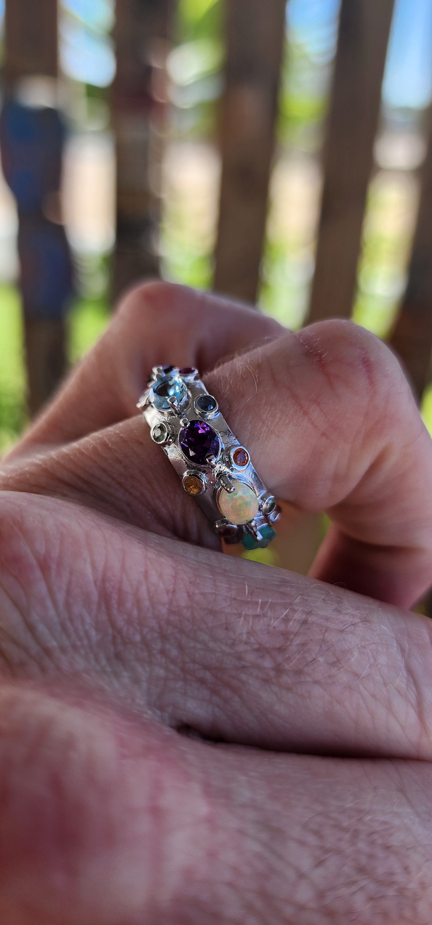 This Tutti Frutti Full Eternity Cocktail Ring is a riot of color, an exquisite fusion of light and energy, crafted in solid sterling silver and adorned with a spectacular array of natural gemstones.