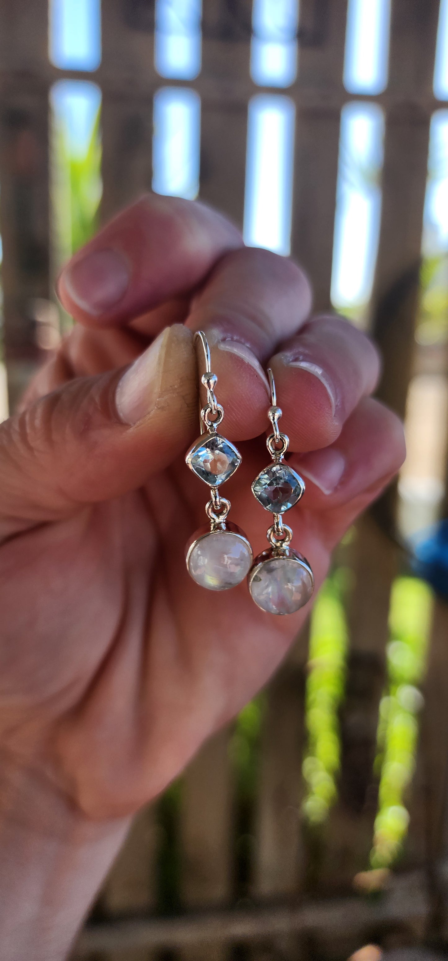 These sterling silver drop earrings exude an ethereal elegance, perfectly blending soft celestial hues with a delicate, fluid movement.