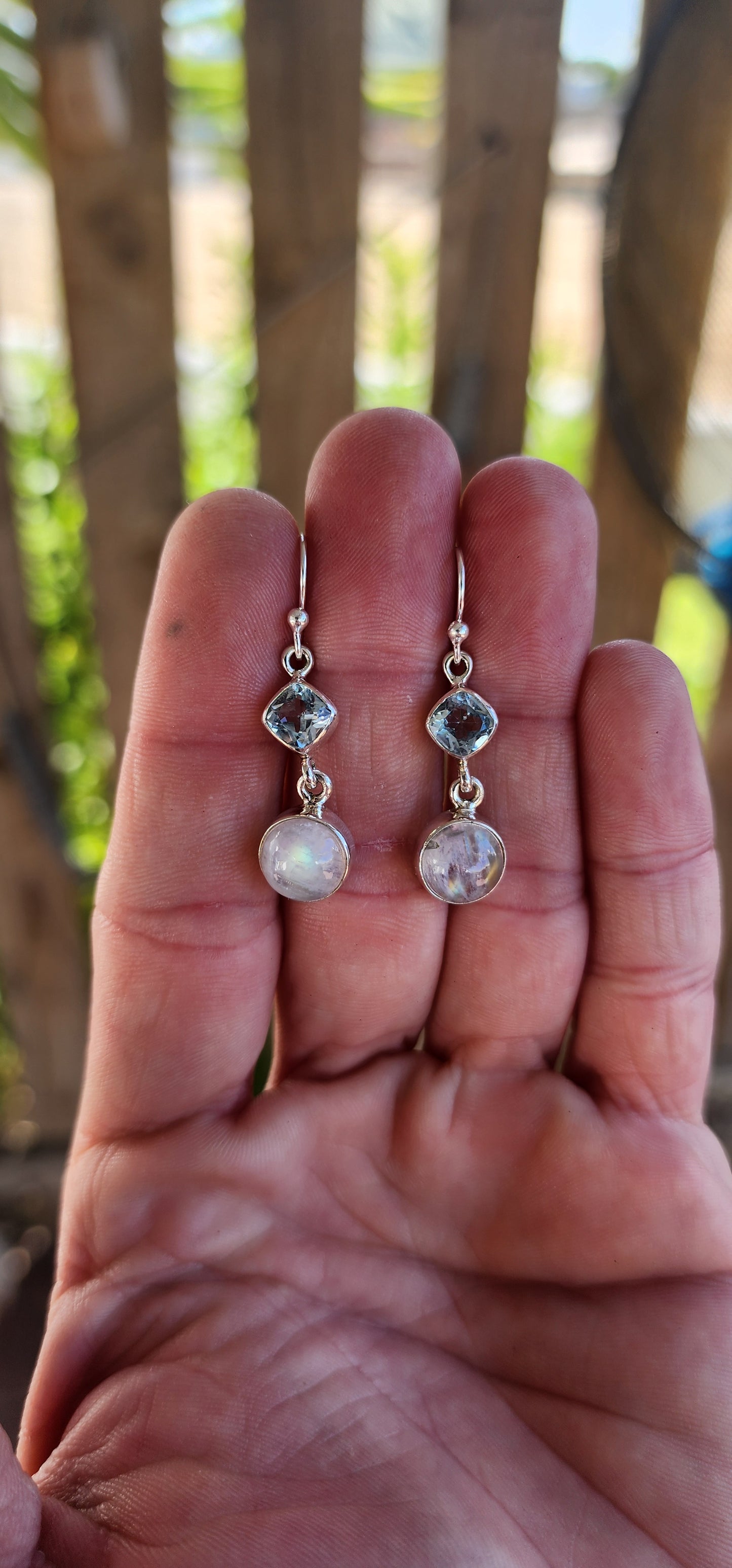 These sterling silver drop earrings exude an ethereal elegance, perfectly blending soft celestial hues with a delicate, fluid movement.