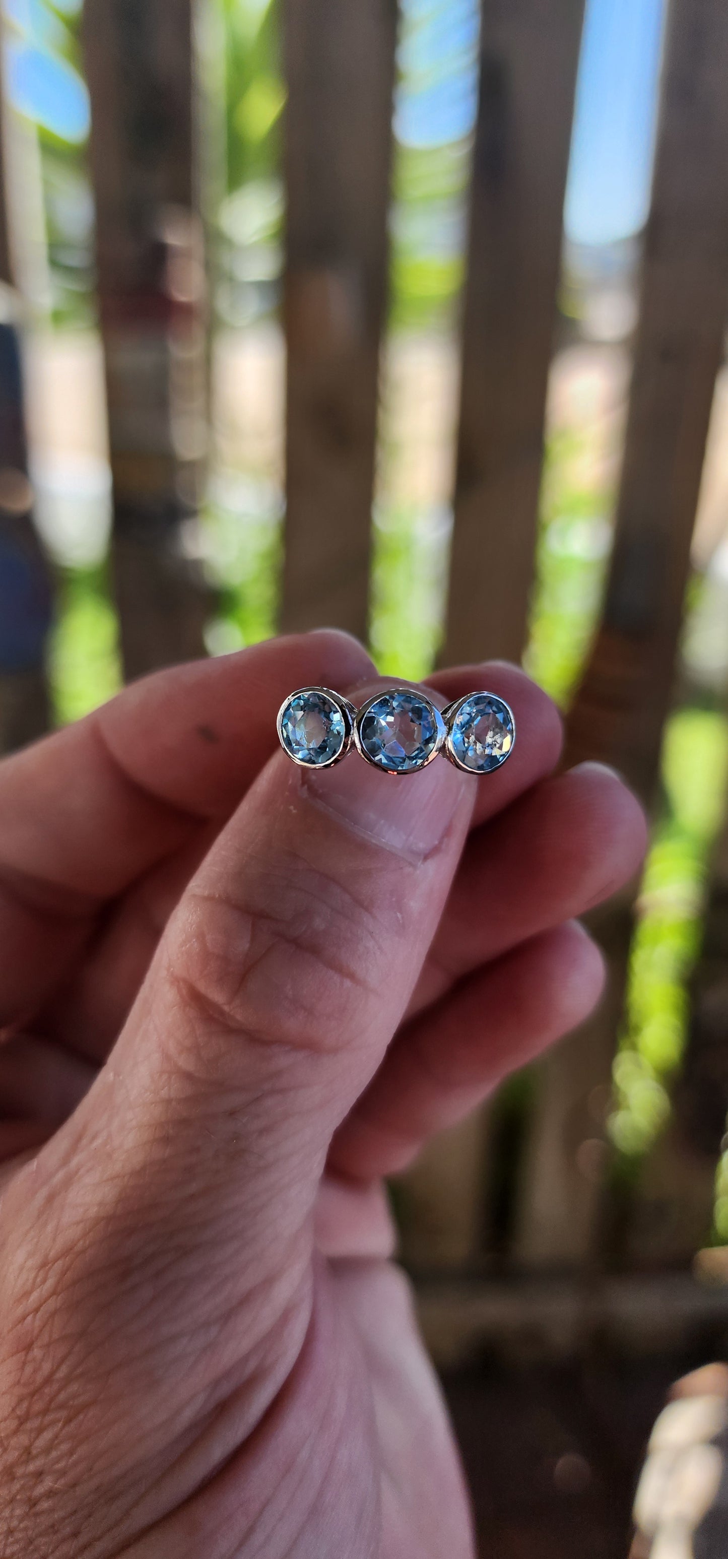 This Sterling Silver and Sky Blue Topaz Trilogy Ring is a true embodiment of timeless elegance, capturing the serene beauty of a clear sky on a perfect day.