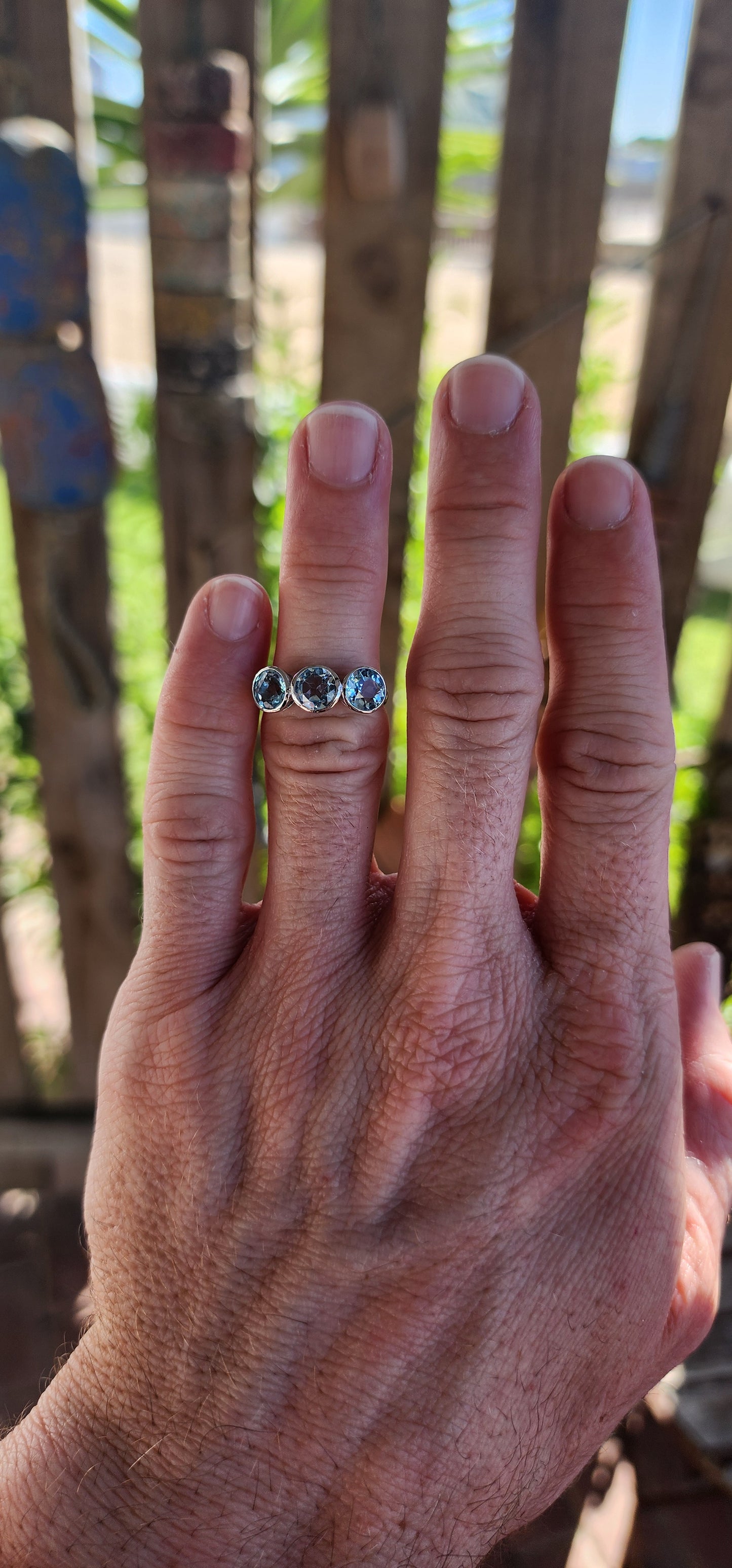 This Sterling Silver and Sky Blue Topaz Trilogy Ring is a true embodiment of timeless elegance, capturing the serene beauty of a clear sky on a perfect day.
