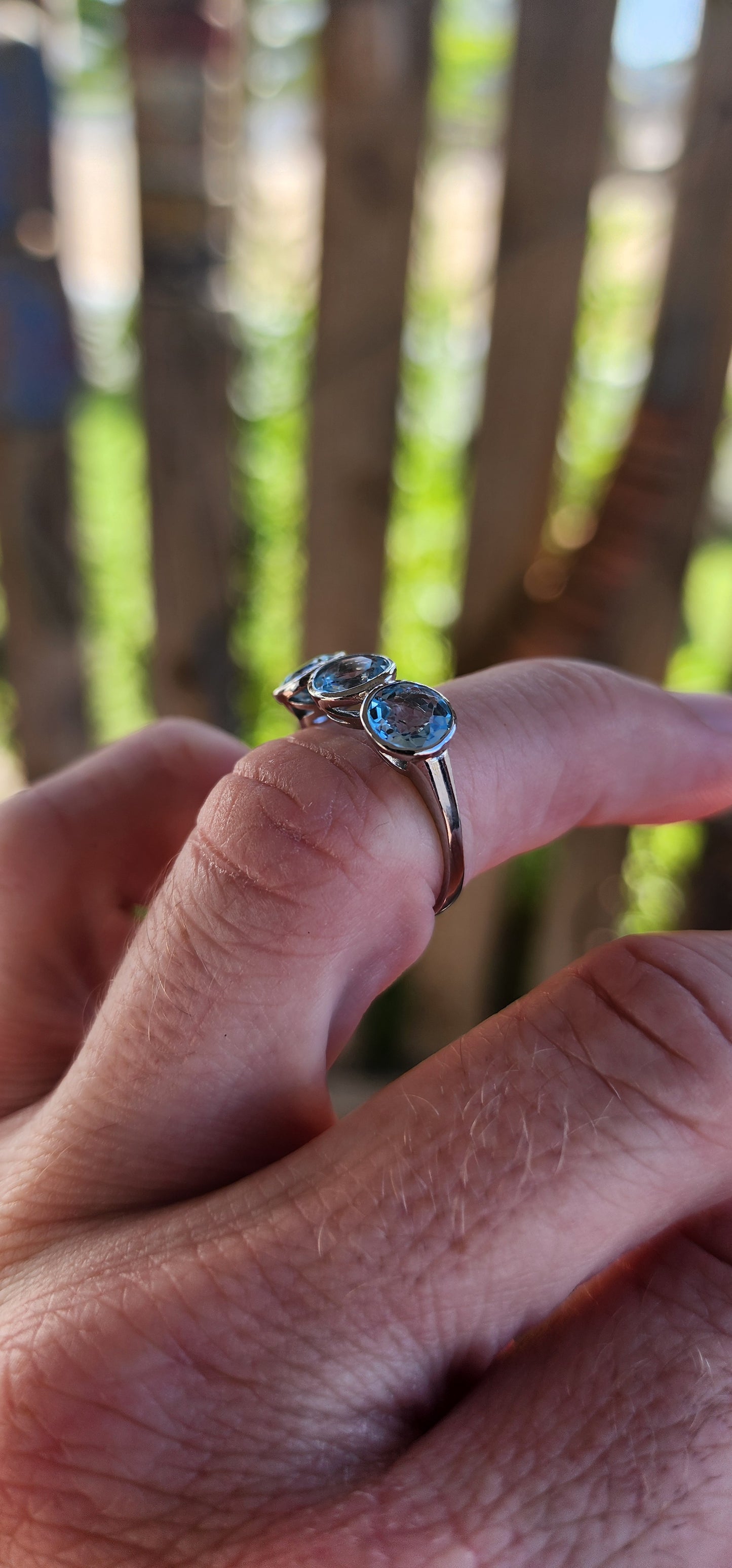 This Sterling Silver and Sky Blue Topaz Trilogy Ring is a true embodiment of timeless elegance, capturing the serene beauty of a clear sky on a perfect day.