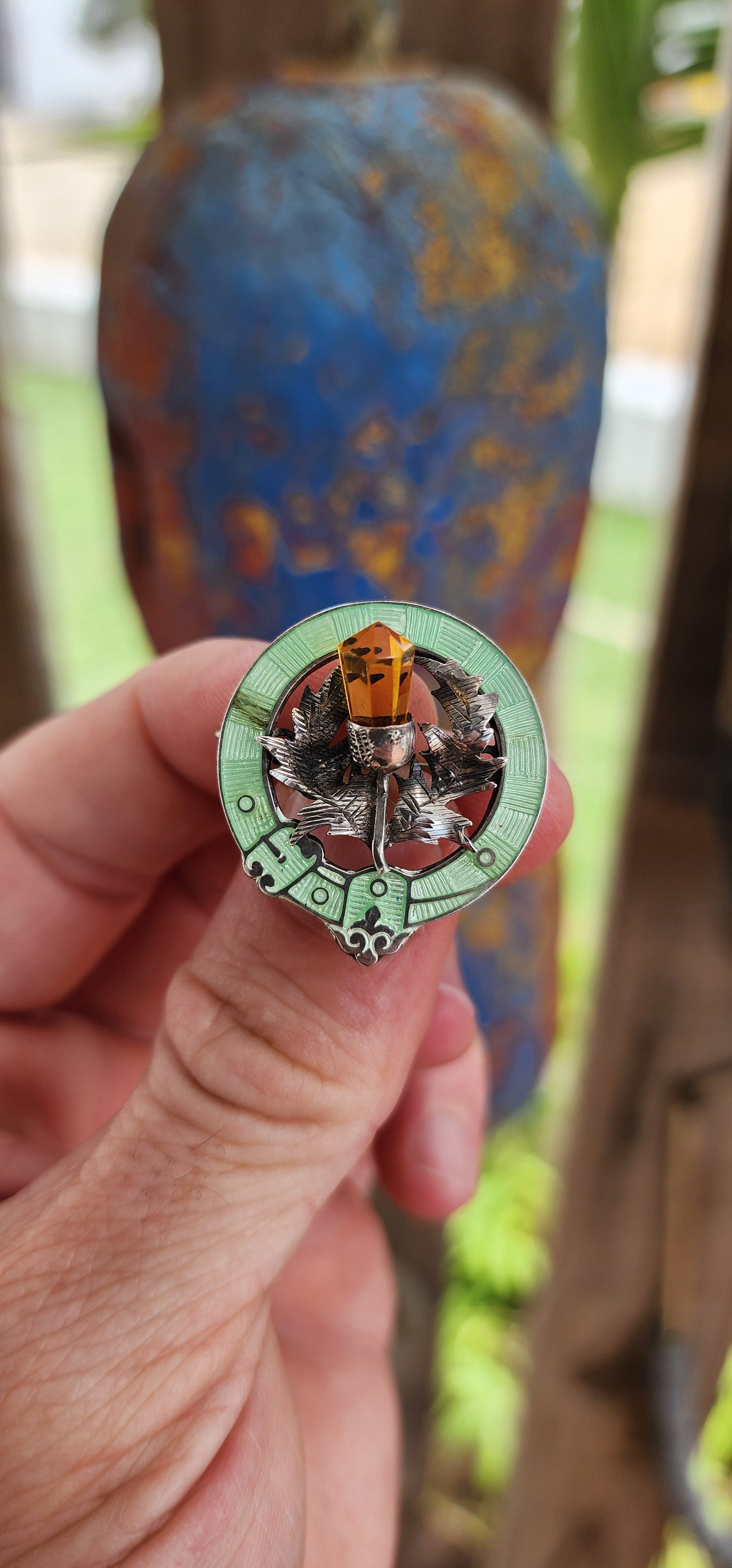 This antique Scottish brooch from circa 1916, made by Adie & Lovekin Ltd in Chester, is a remarkable piece featuring hallmarked sterling silver, citrine, and rare lime-green guilloché enamel.