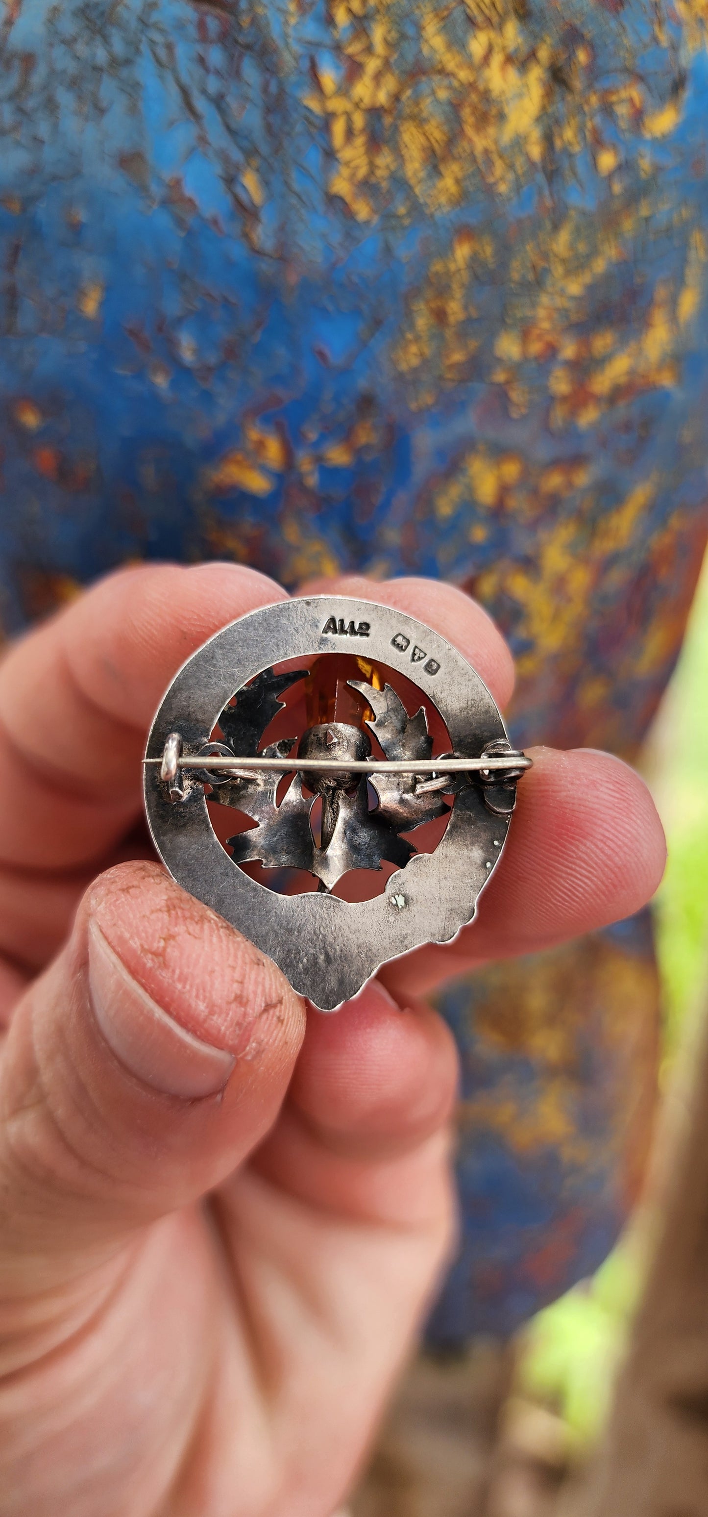 This antique Scottish brooch from circa 1916, made by Adie & Lovekin Ltd in Chester, is a remarkable piece featuring hallmarked sterling silver, citrine, and rare lime-green guilloché enamel.