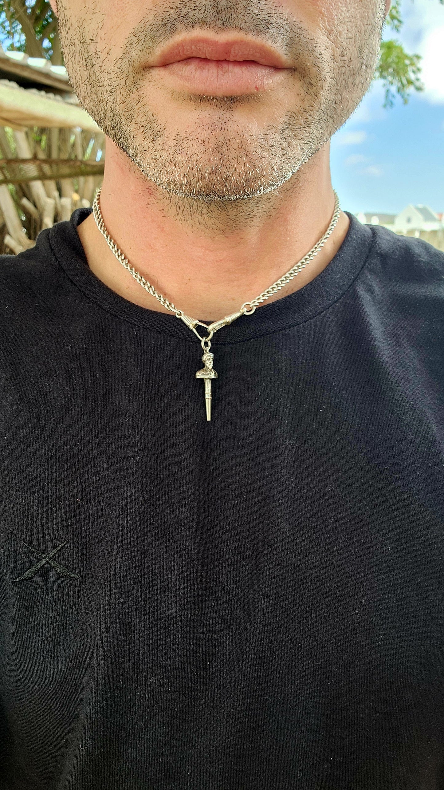 This is a 19th-century antique sterling silver pocket watch winding key pendant, crafted in a novelty figural design, featuring the bust of a bearded man wearing a turban or classical headpiece.