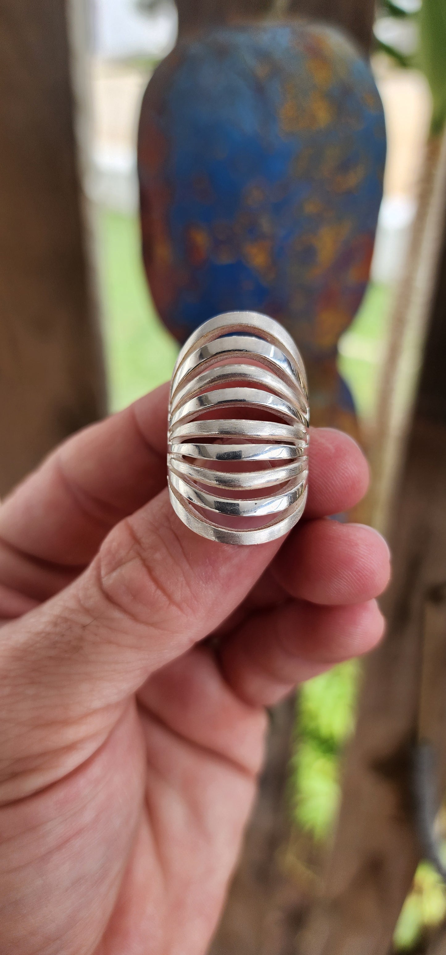 This striking sterling silver statement ring is a bold expression of modernist artistry, seamlessly blending sculptural aesthetics with wearable design.