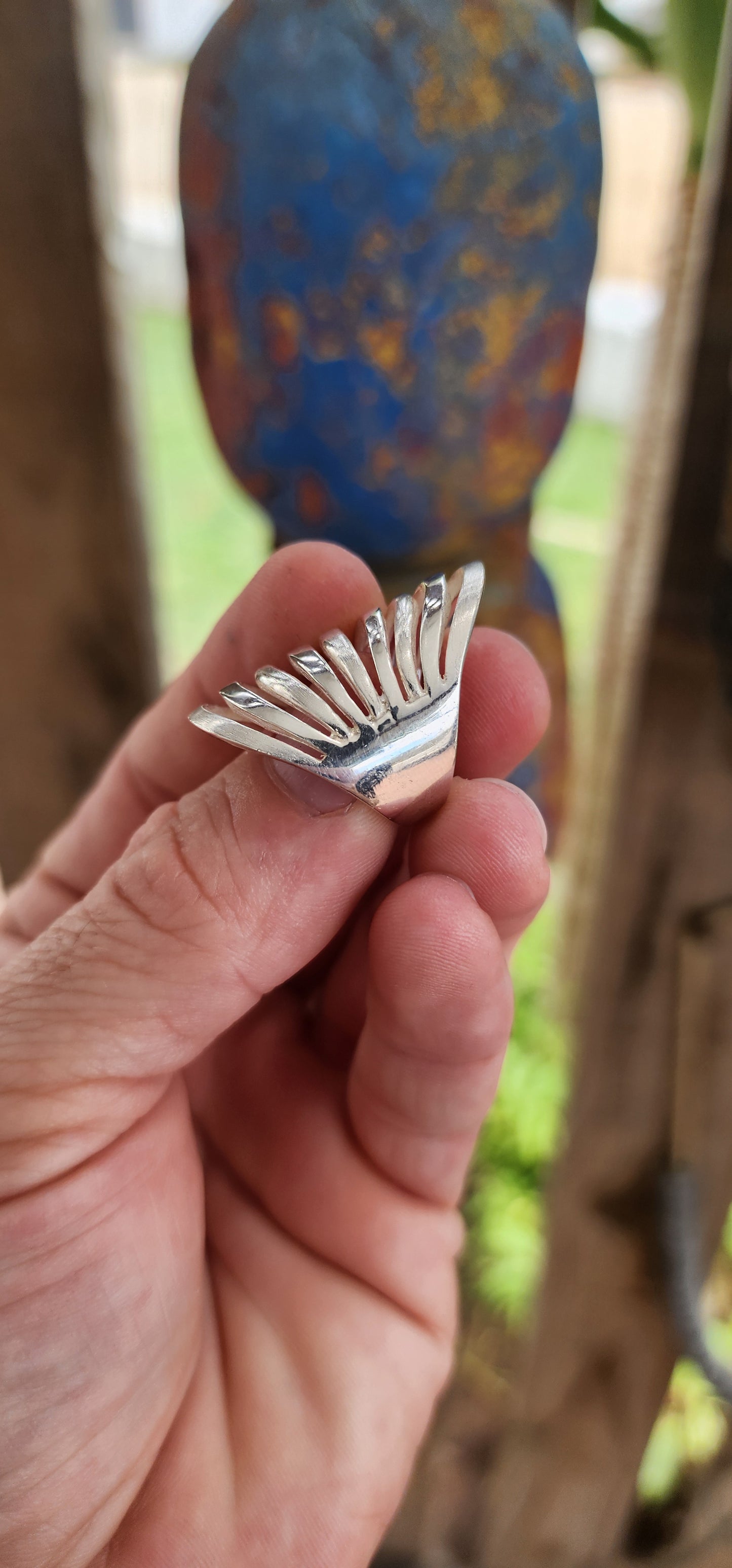 This striking sterling silver statement ring is a bold expression of modernist artistry, seamlessly blending sculptural aesthetics with wearable design.