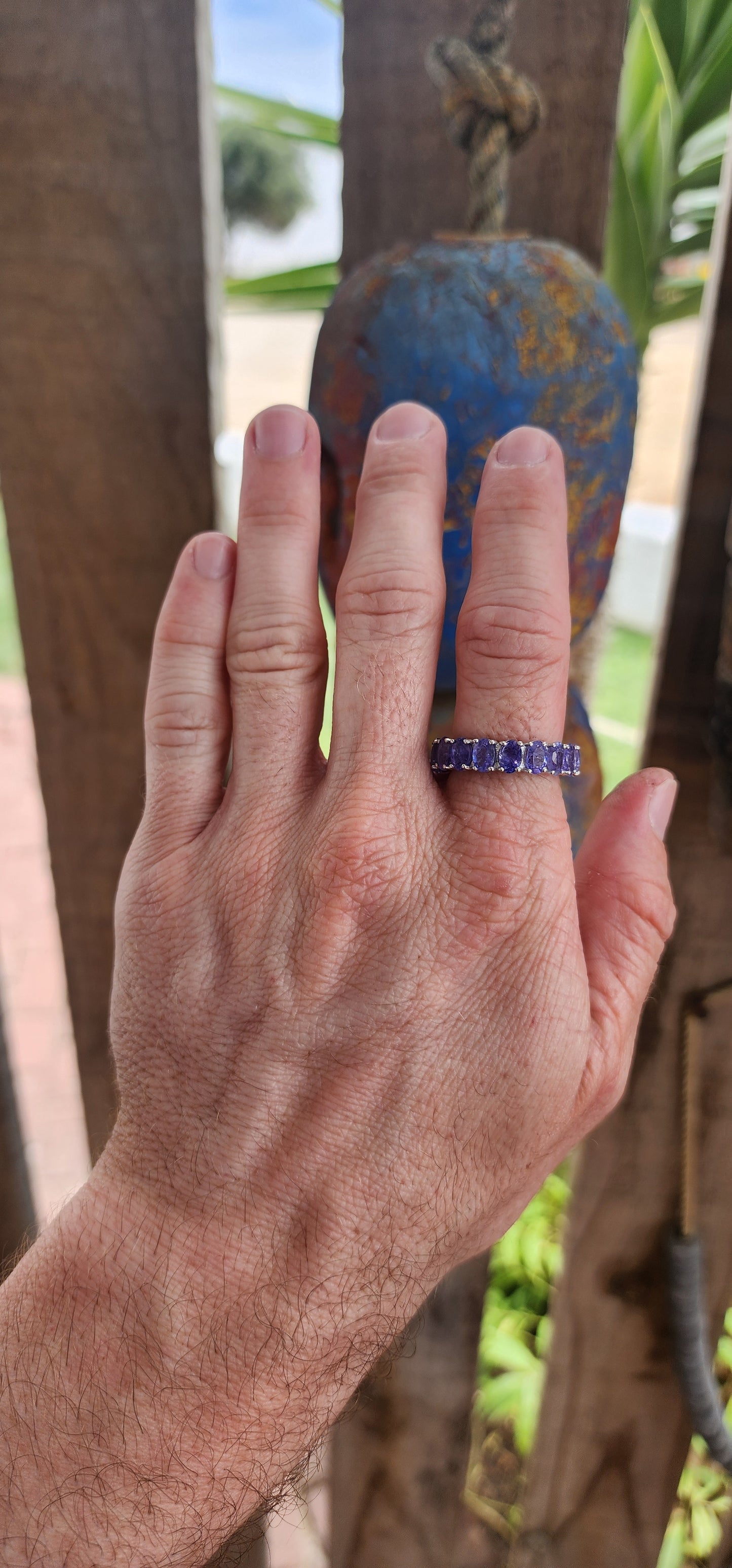 This exquisite full eternity ring is a testament to masterful craftsmanship and timeless elegance. Expertly forged in polished sterling silver, the ring showcases a seamless circle of 17 oval-cut Tanzanite gemstones.