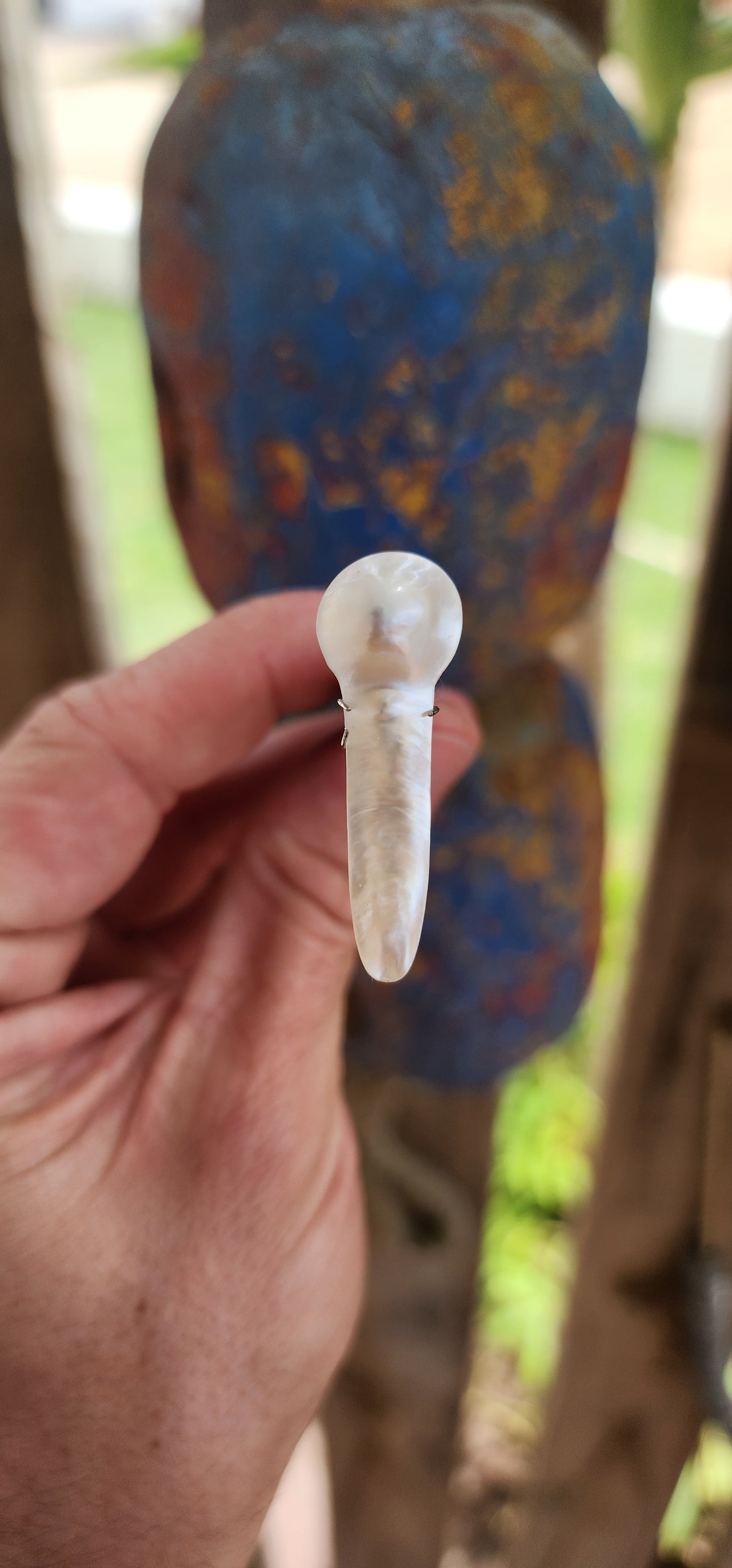 A breathtakingly unique and organically sculpted large blister pearl, radiating with an ethereal glow and mesmerizing iridescence.