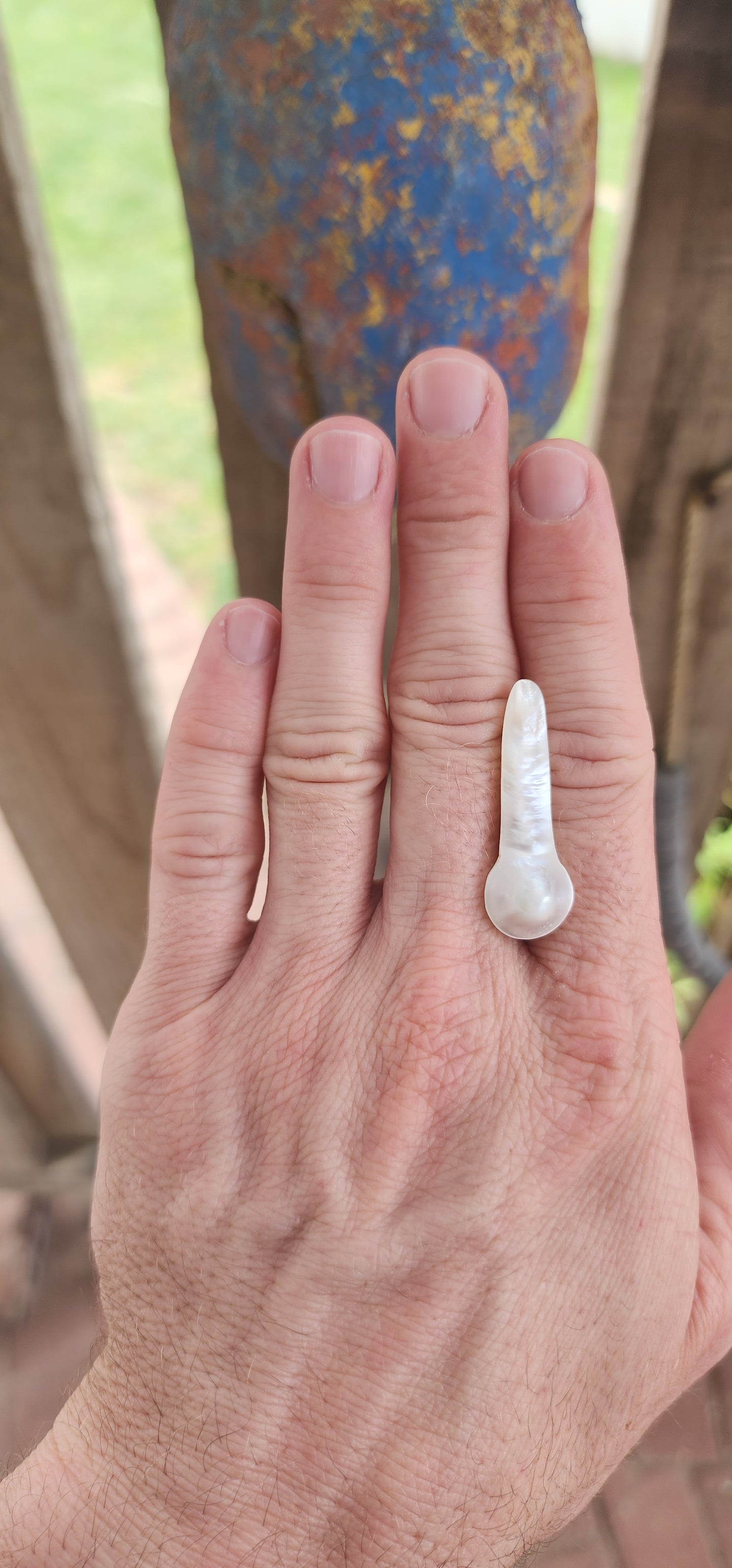 A breathtakingly unique and organically sculpted large blister pearl, radiating with an ethereal glow and mesmerizing iridescence.