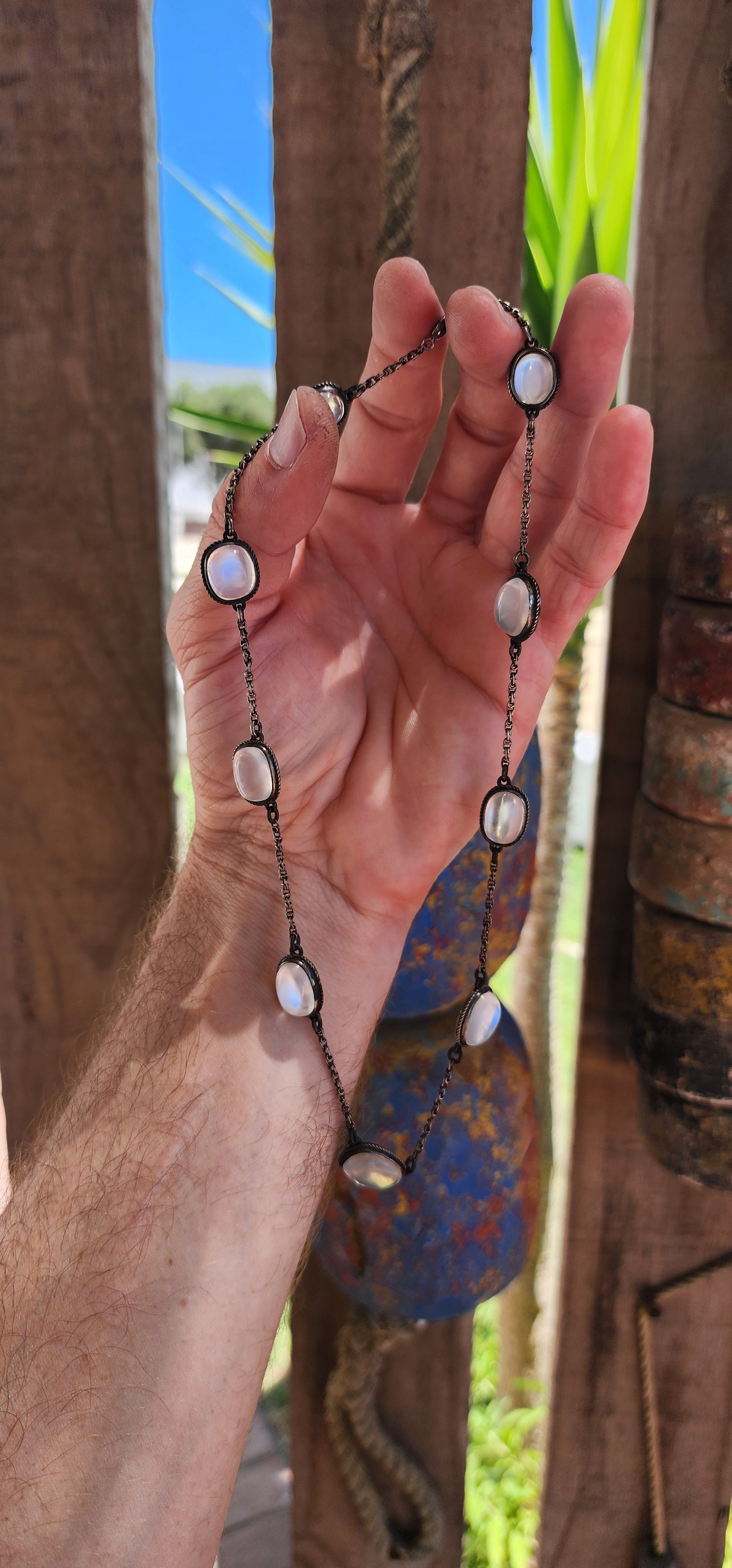 This exquisite antique moonstone rivière style necklace is a prime example of late Victorian to early Edwardian jewelry, specifically reflecting the principles of the Arts & Crafts movement (c. 1890–1910).