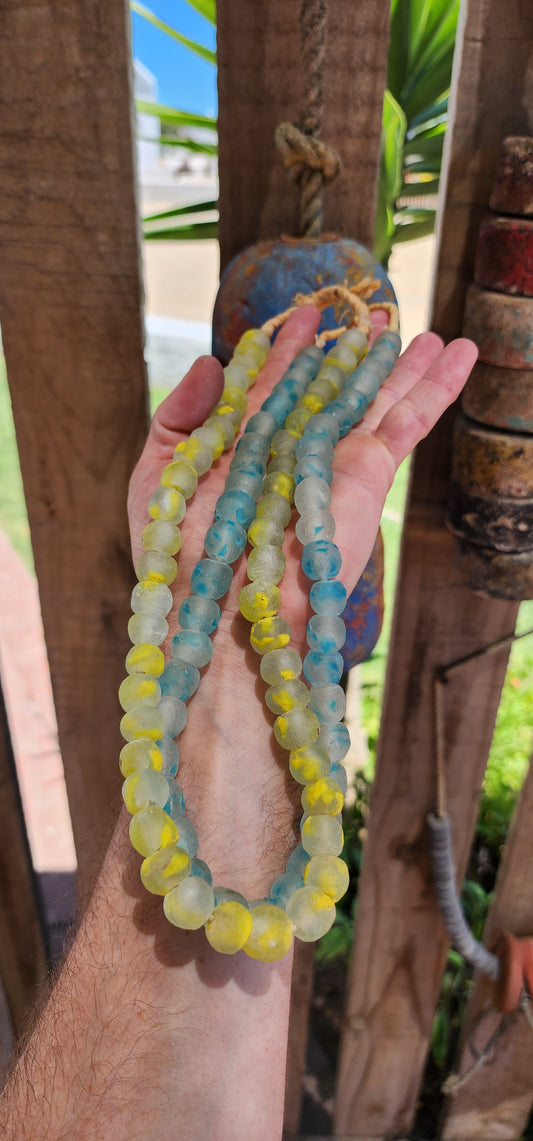 These chunky Krobo recycled glass necklaces are like little bursts of West African sunshine and ocean waves, captured in bead form.