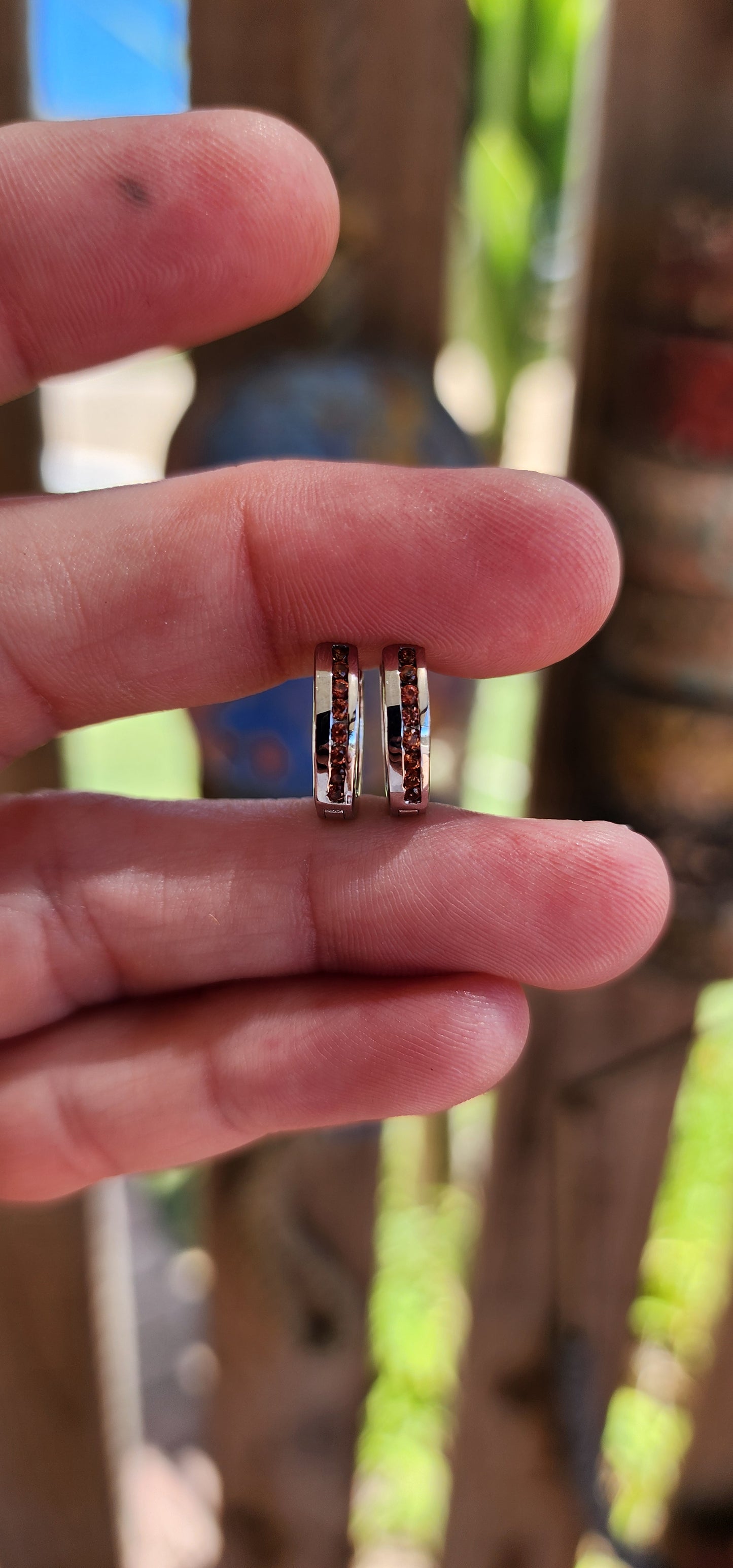 These petite sterling silver hoop earrings are like tiny sunsets, blending classic elegance with a fiery touch of color.