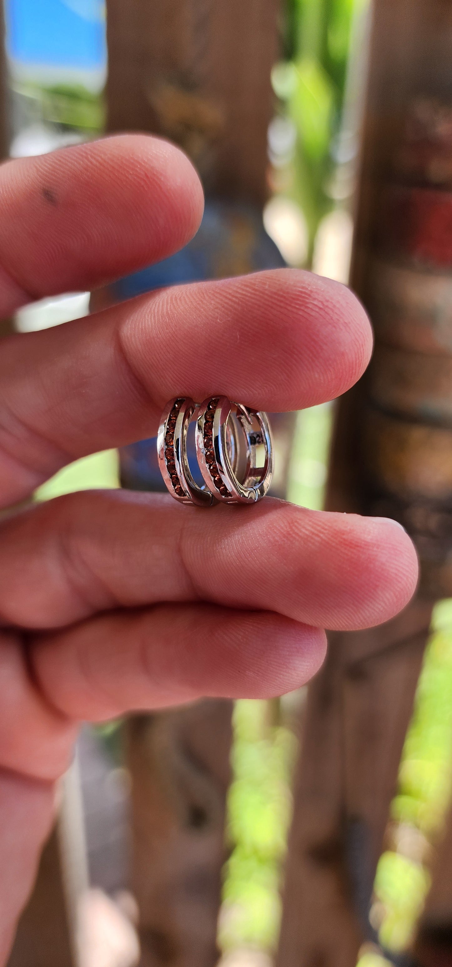 These petite sterling silver hoop earrings are like tiny sunsets, blending classic elegance with a fiery touch of color.