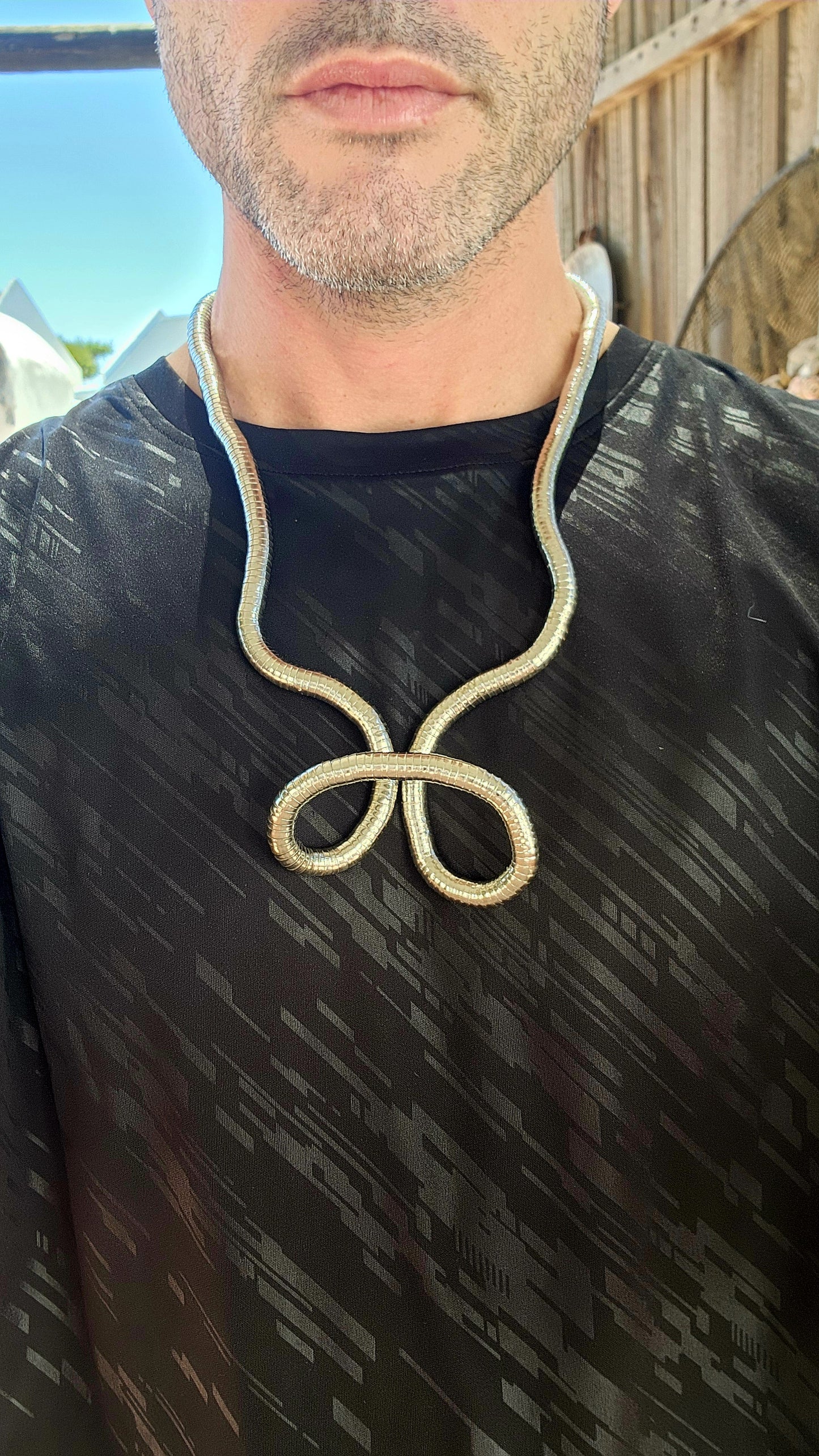 This vintage 90's silvertone transformer snake necklace is a remarkable fusion of modernist design and playful versatility, making it a standout in the world of articulated jewelry.