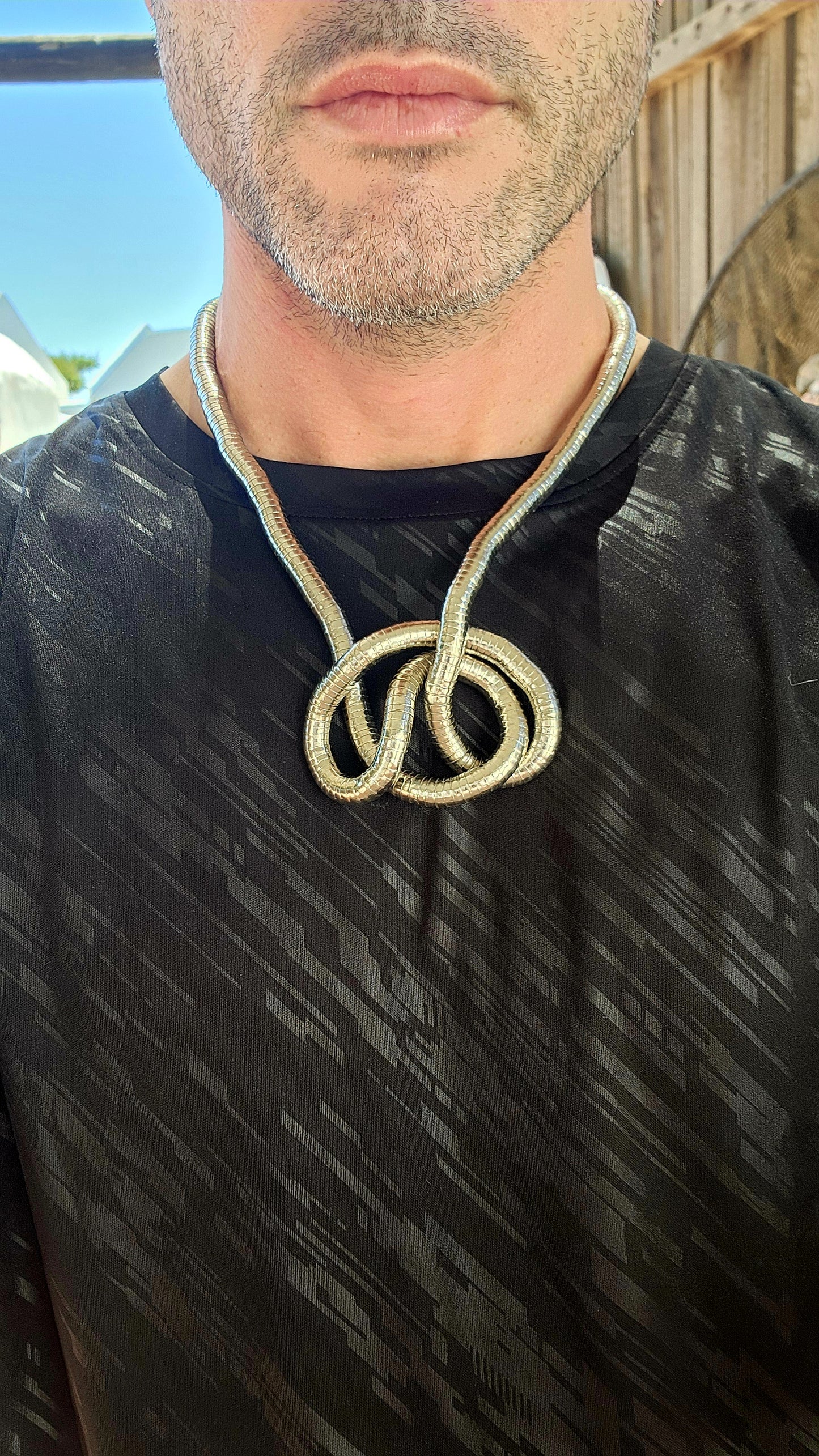 This vintage 90's silvertone transformer snake necklace is a remarkable fusion of modernist design and playful versatility, making it a standout in the world of articulated jewelry.