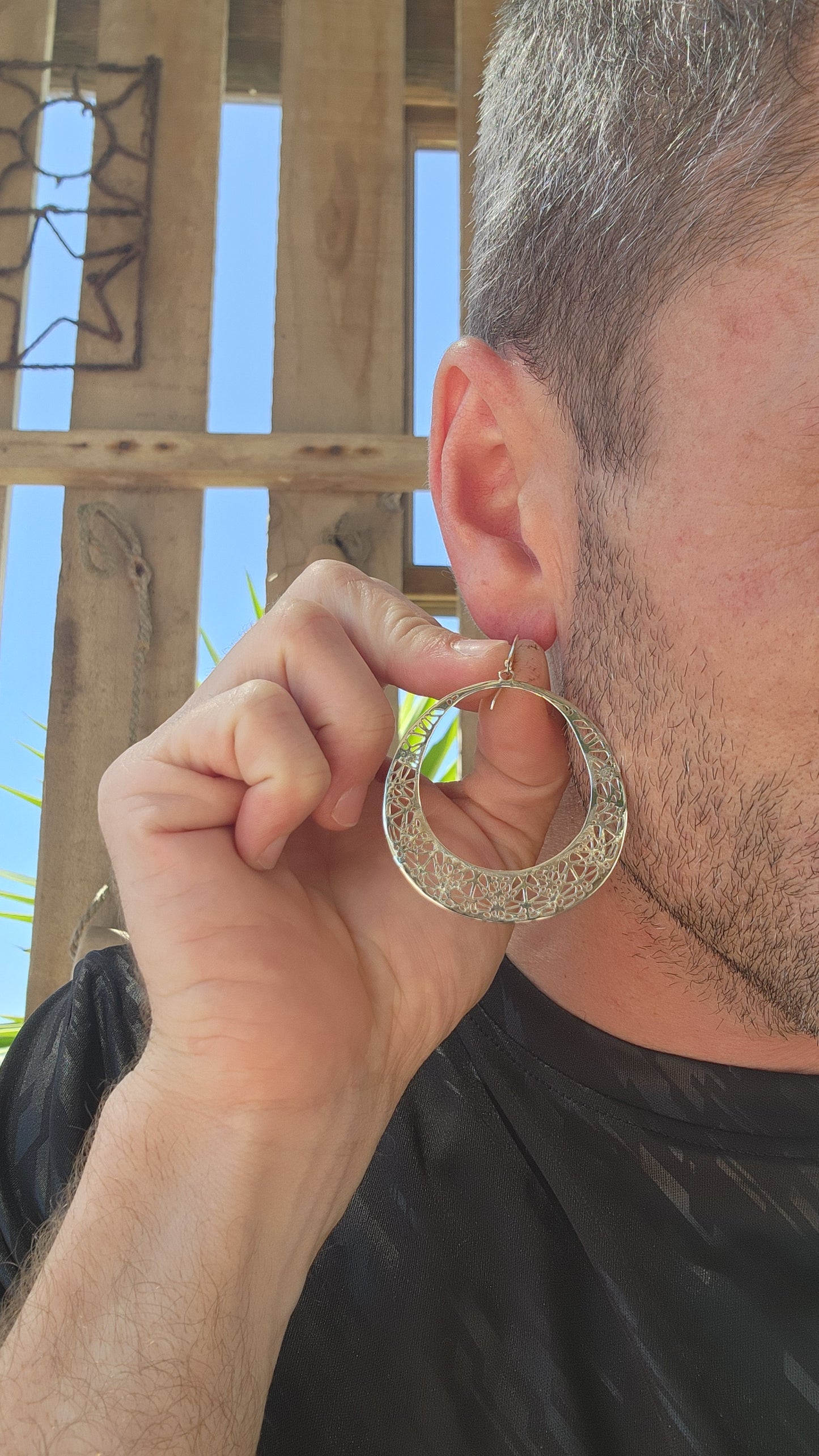 These oversized sterling silver hoop dangle earrings are an exquisite example of fine craftsmanship, blending timeless elegance with a touch of intricate artistry.