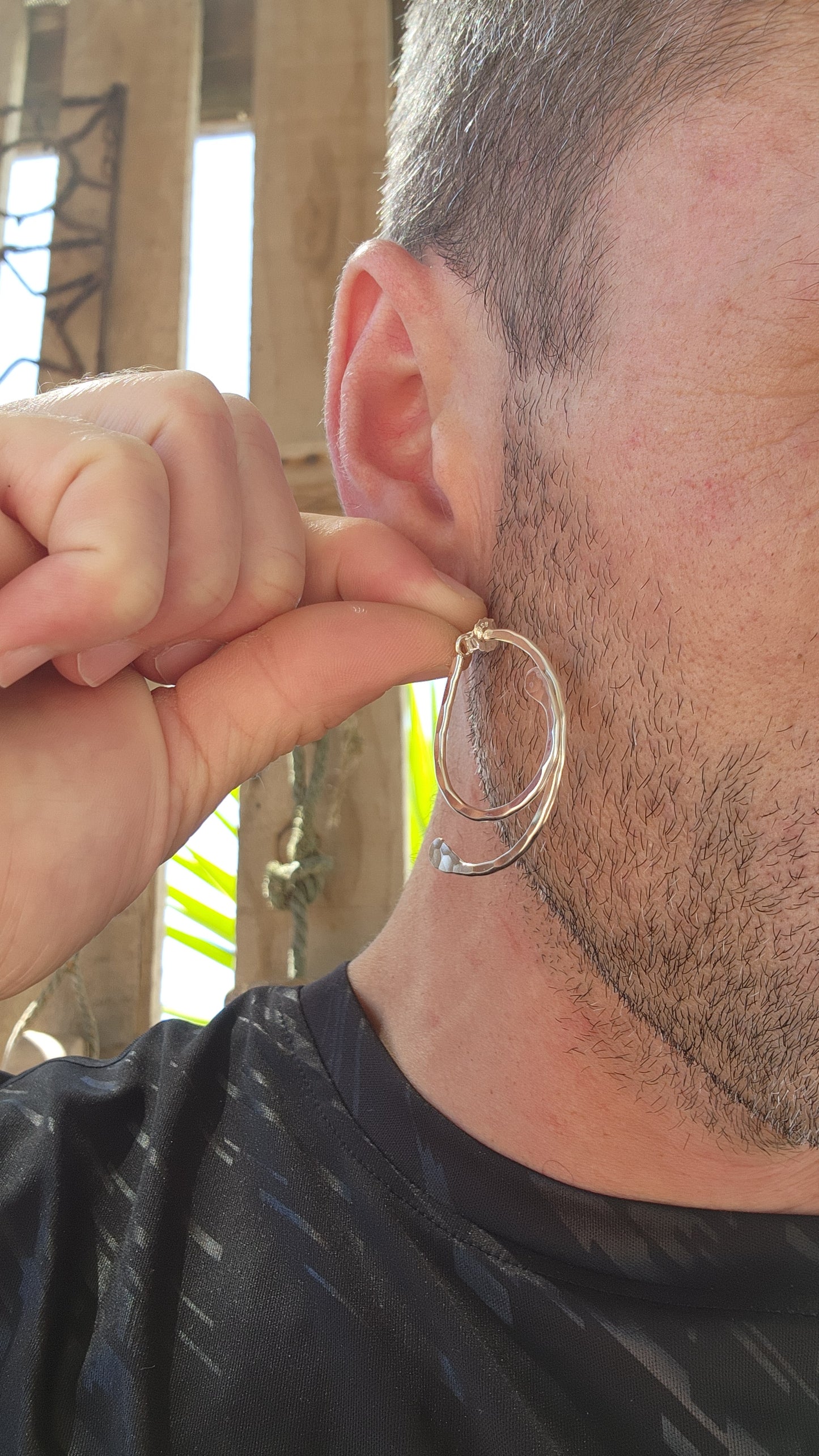 These earrings are a brilliant fusion of contemporary artistry and optical illusion! Crafted from hammered sterling silver, they feature an intriguing twisted double-half hoop design that plays with depth and dimension.