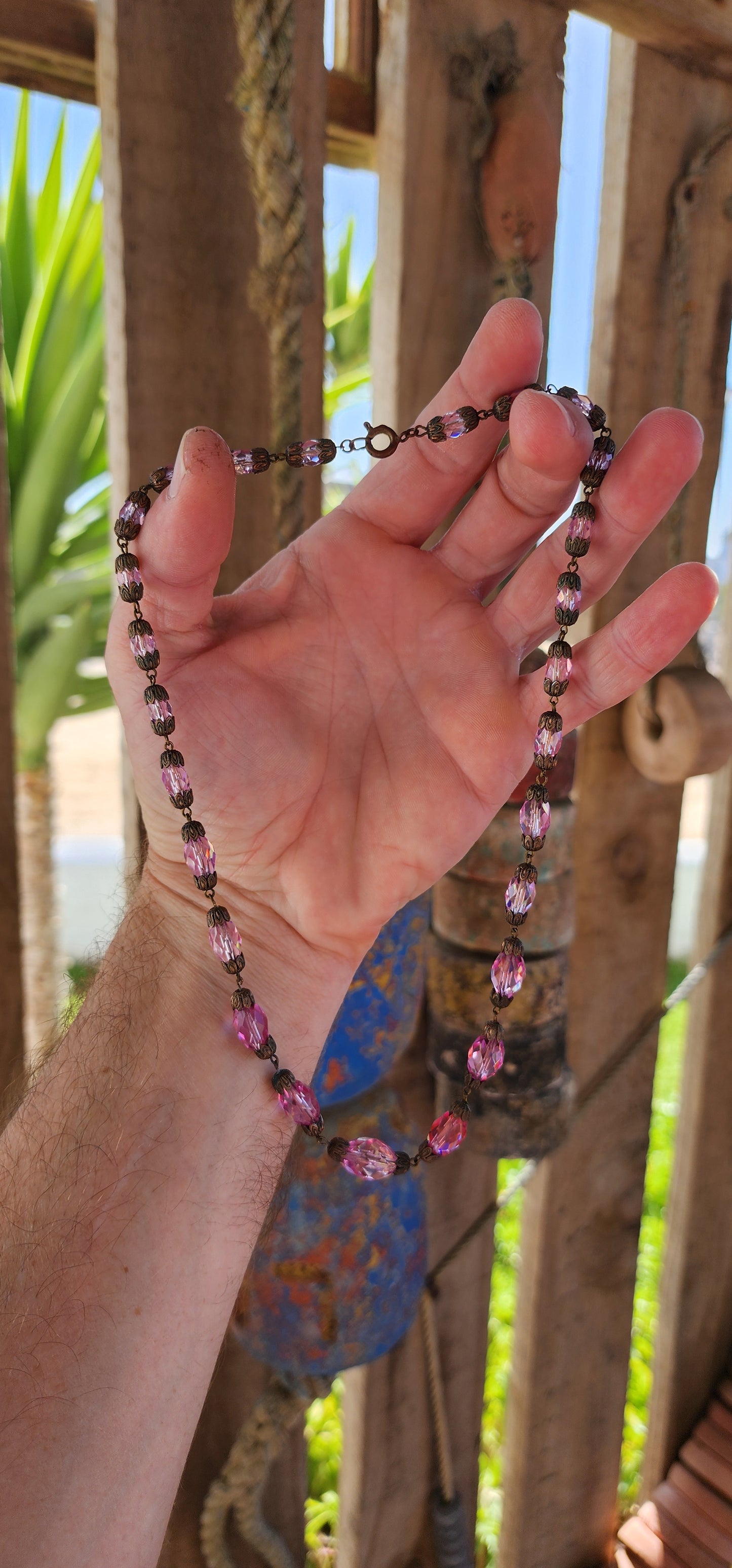 This exquisite antique 1920s Pink Czech crystal necklace is a delicate symphony of light and color, masterfully crafted with graduated faceted pink crystal beads that shimmer with every movement.