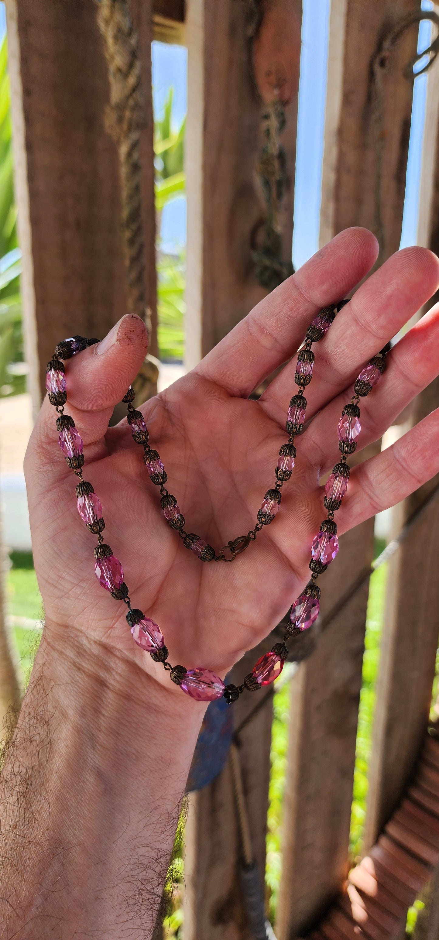 This exquisite antique 1920s Pink Czech crystal necklace is a delicate symphony of light and color, masterfully crafted with graduated faceted pink crystal beads that shimmer with every movement.