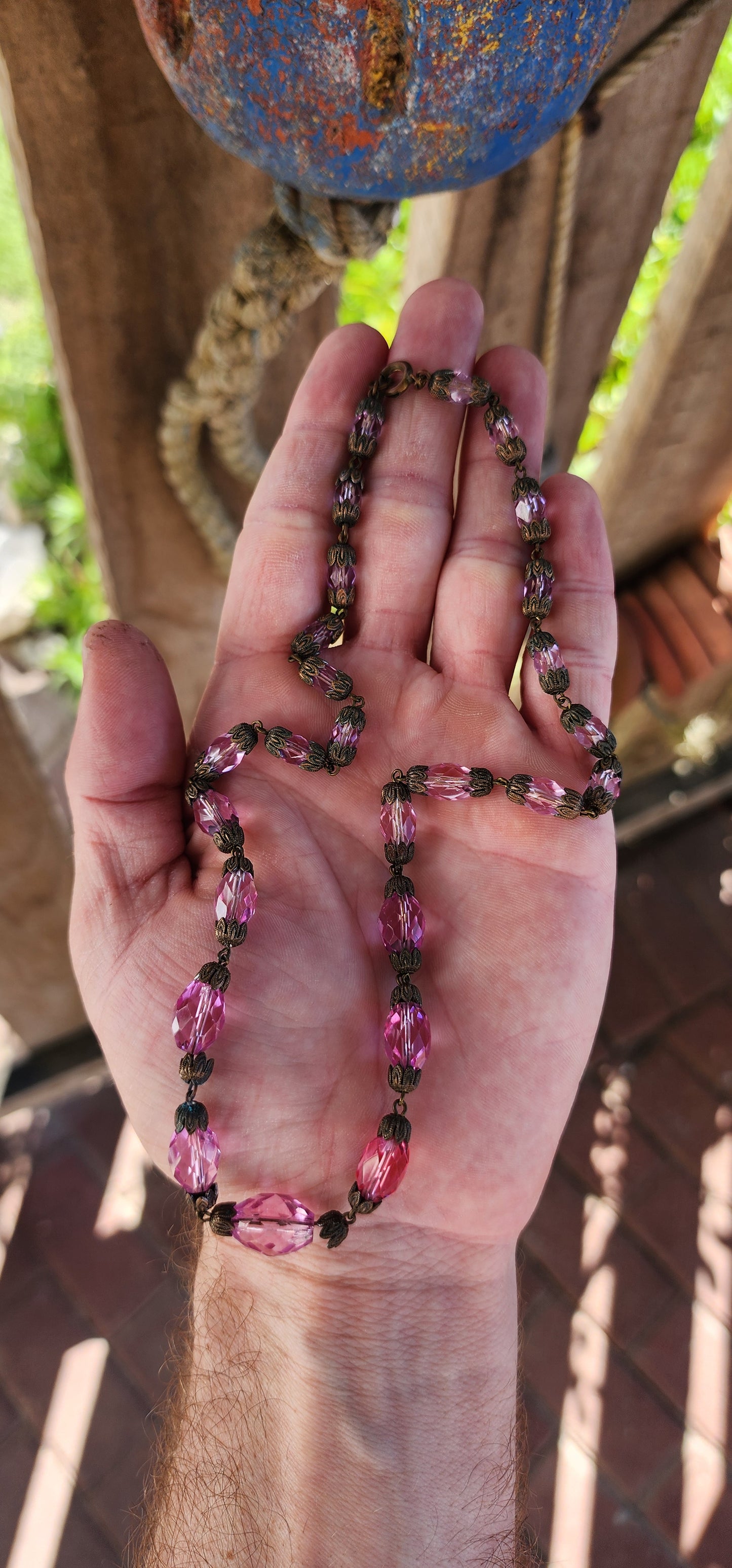 This exquisite antique 1920s Pink Czech crystal necklace is a delicate symphony of light and color, masterfully crafted with graduated faceted pink crystal beads that shimmer with every movement.