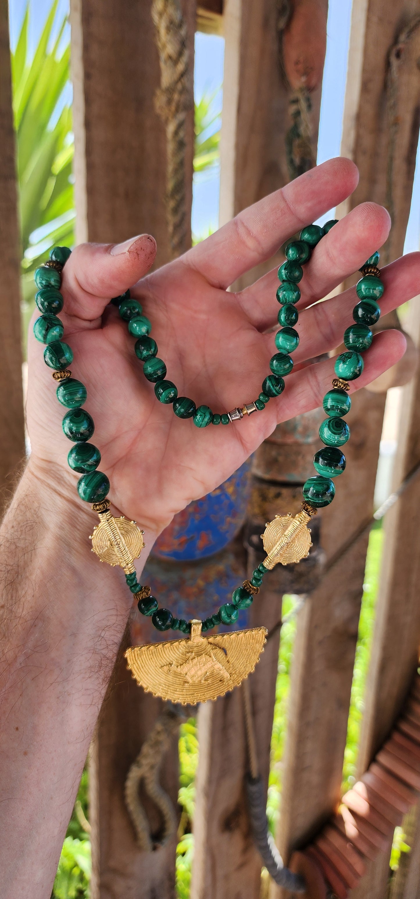 This Ghanaian necklace is a bold and striking piece that beautifully merges natural elegance with African artistry. Featuring highly polished malachite beads, the deep green hues with mesmerizing swirling patterns evoke the rich landscapes of Africa.