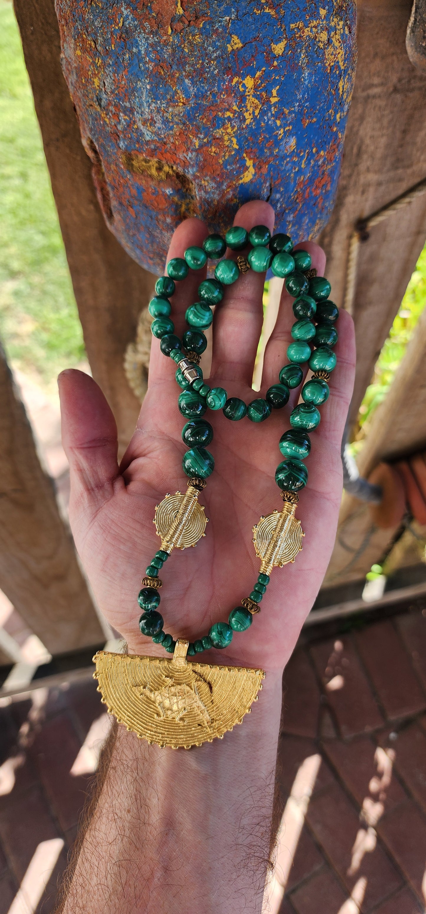 This Ghanaian necklace is a bold and striking piece that beautifully merges natural elegance with African artistry. Featuring highly polished malachite beads, the deep green hues with mesmerizing swirling patterns evoke the rich landscapes of Africa.