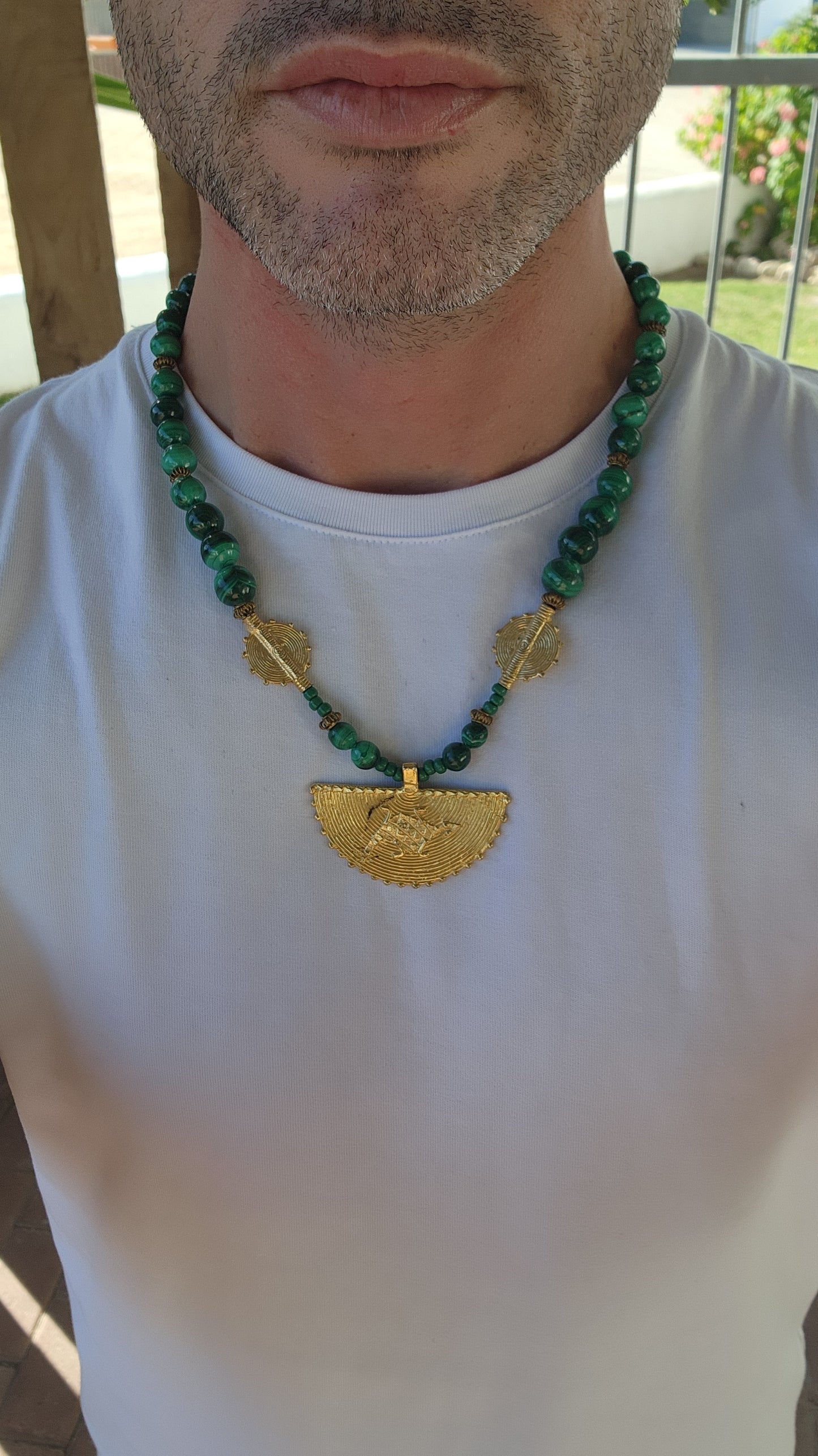 This Ghanaian necklace is a bold and striking piece that beautifully merges natural elegance with African artistry. Featuring highly polished malachite beads, the deep green hues with mesmerizing swirling patterns evoke the rich landscapes of Africa.