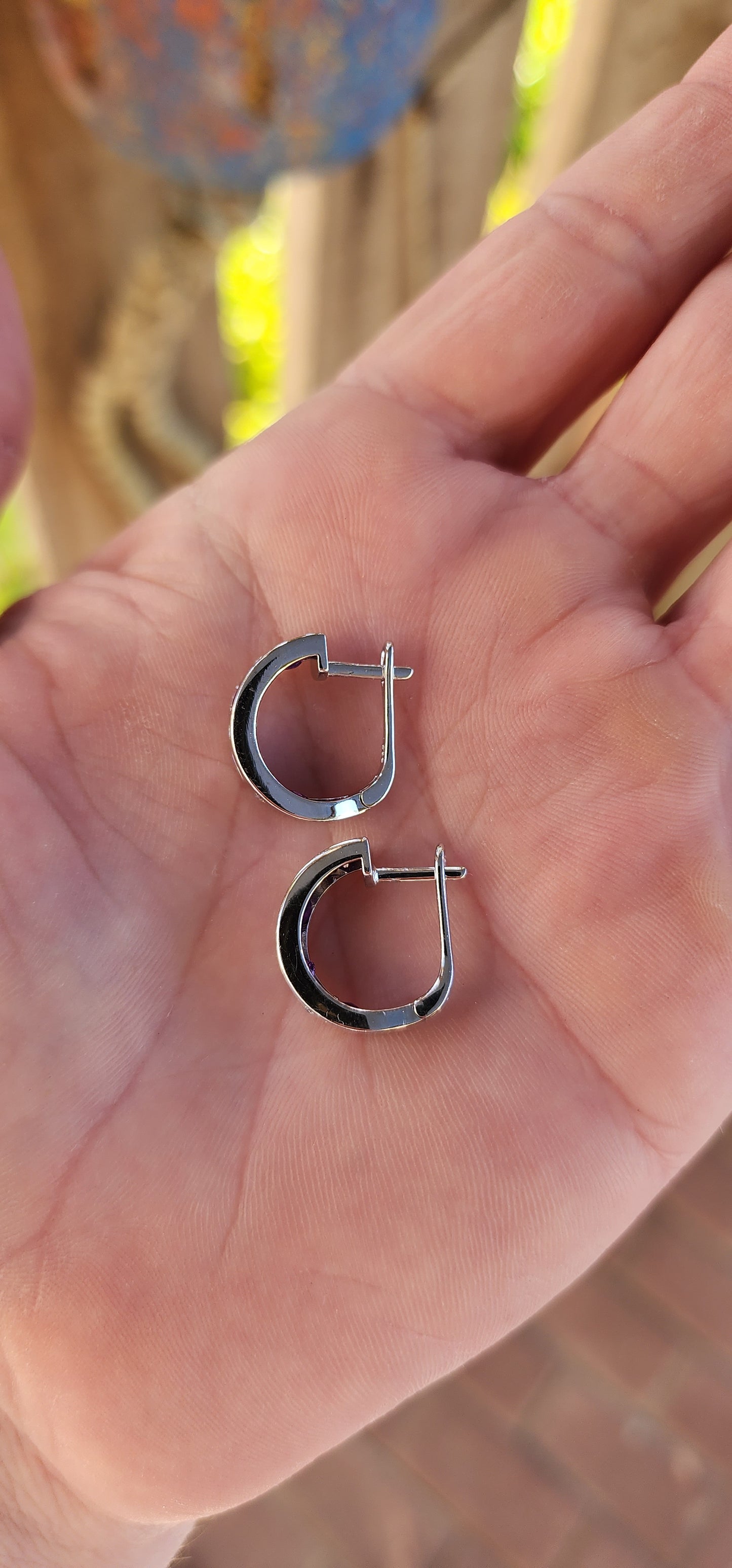 These sterling silver half-hoop earrings are absolutely stunning, designed for those who appreciate both beauty and practicality. Their graceful half-hoop silhouette allows them to dangle effortlessly, striking the perfect balance.