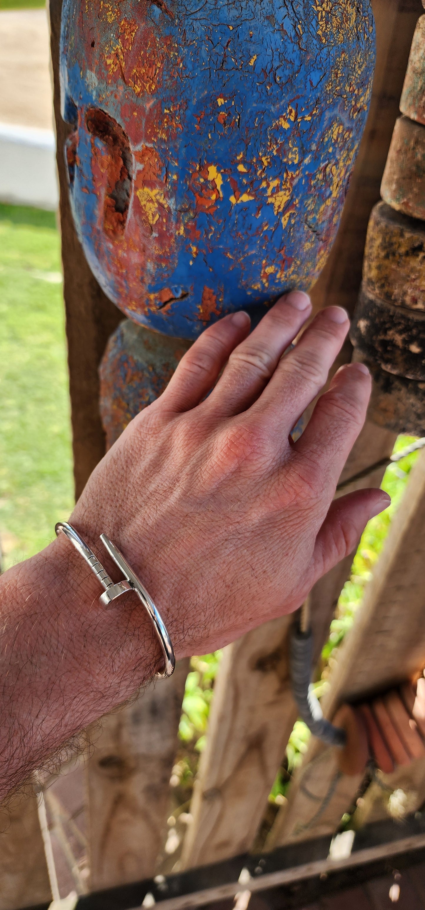 This solid sterling silver nail clip-bangle is a bold, industrial-chic statement piece that fuses rugged edge with high fashion elegance.