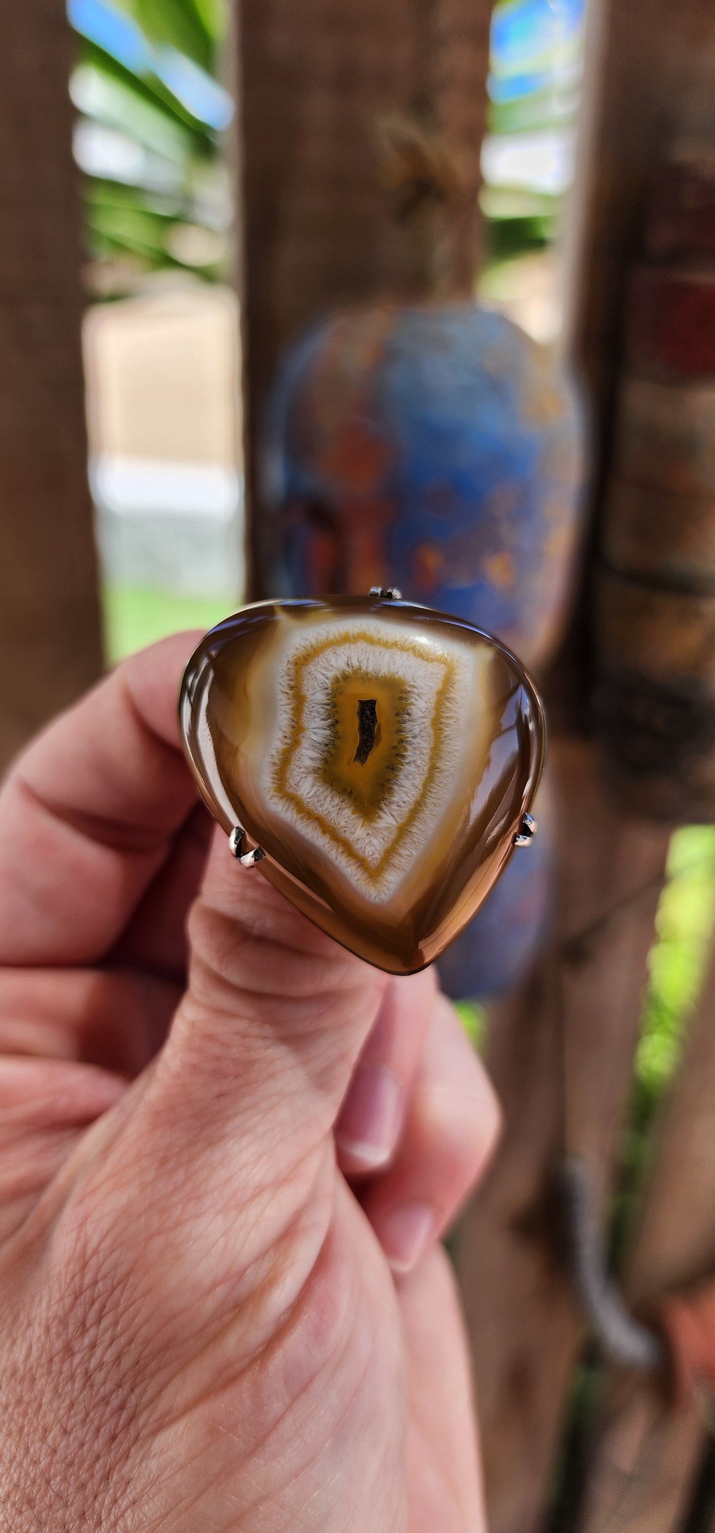 This marvelous vintage mid-century brooch is a stunning fusion of nature’s artistry and classic silver craftsmanship. Featuring a polished banded agate cabochon in its natural organic shape, this piece evokes the mesmerizing gaze of a dragon’s eye.