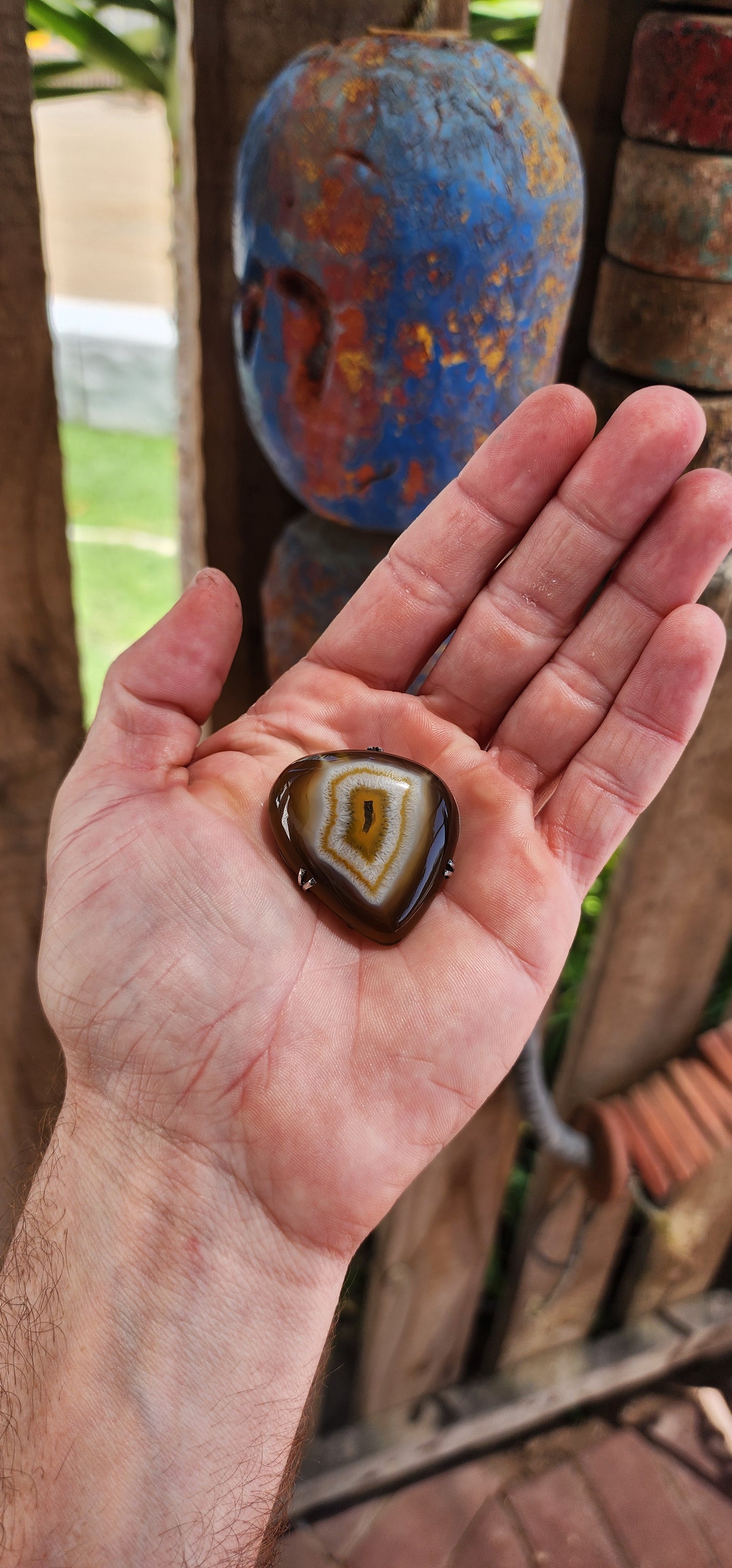 This marvelous vintage mid-century brooch is a stunning fusion of nature’s artistry and classic silver craftsmanship. Featuring a polished banded agate cabochon in its natural organic shape, this piece evokes the mesmerizing gaze of a dragon’s eye.
