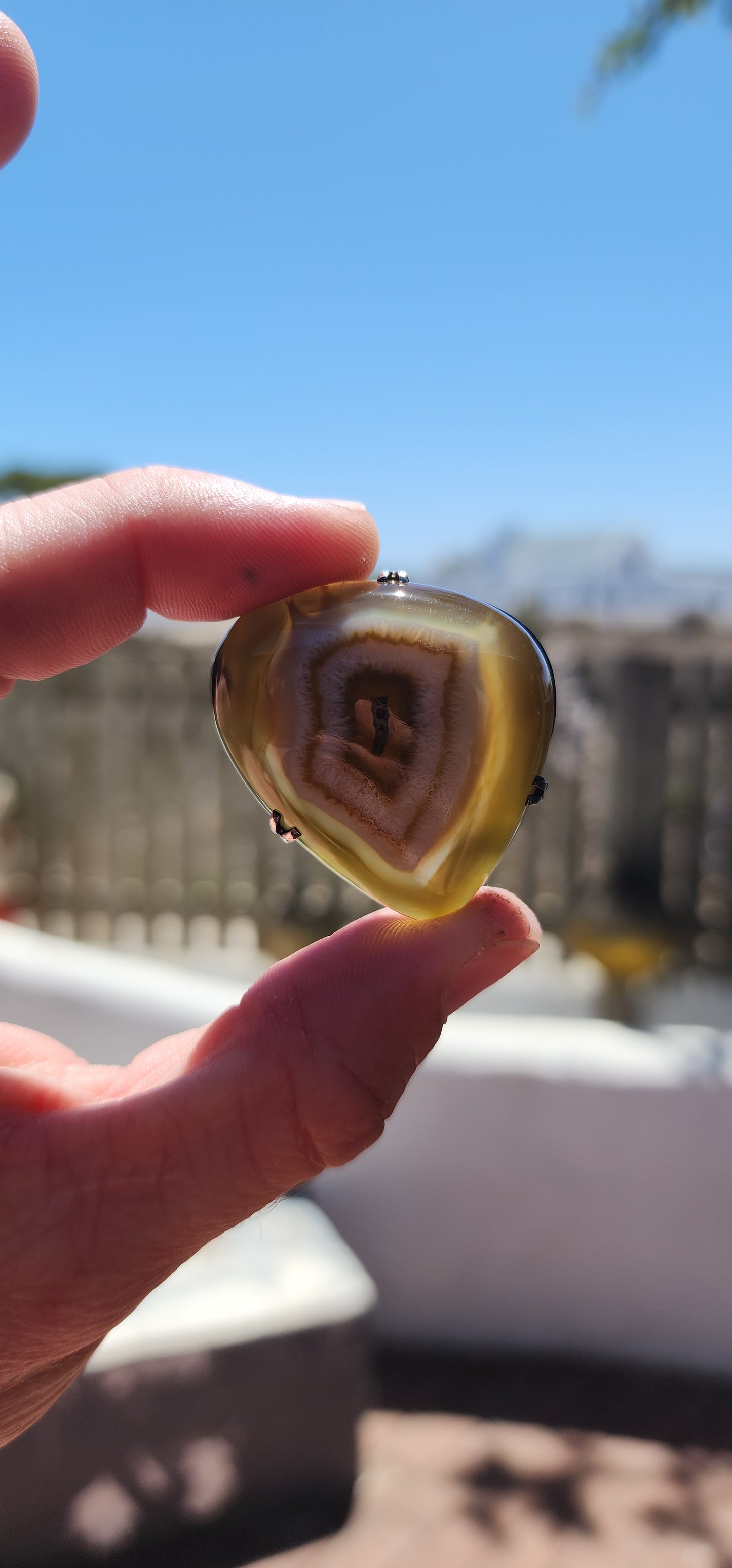 This marvelous vintage mid-century brooch is a stunning fusion of nature’s artistry and classic silver craftsmanship. Featuring a polished banded agate cabochon in its natural organic shape, this piece evokes the mesmerizing gaze of a dragon’s eye.