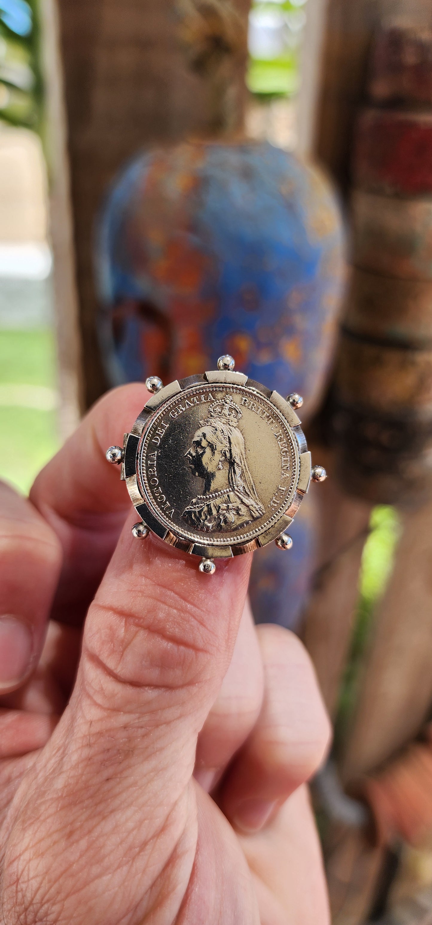 This exquisite antique Victorian-era brooch is crafted in sterling silver and features a 1887 Queen Victoria Jubilee Head silver shilling coin as its central element.