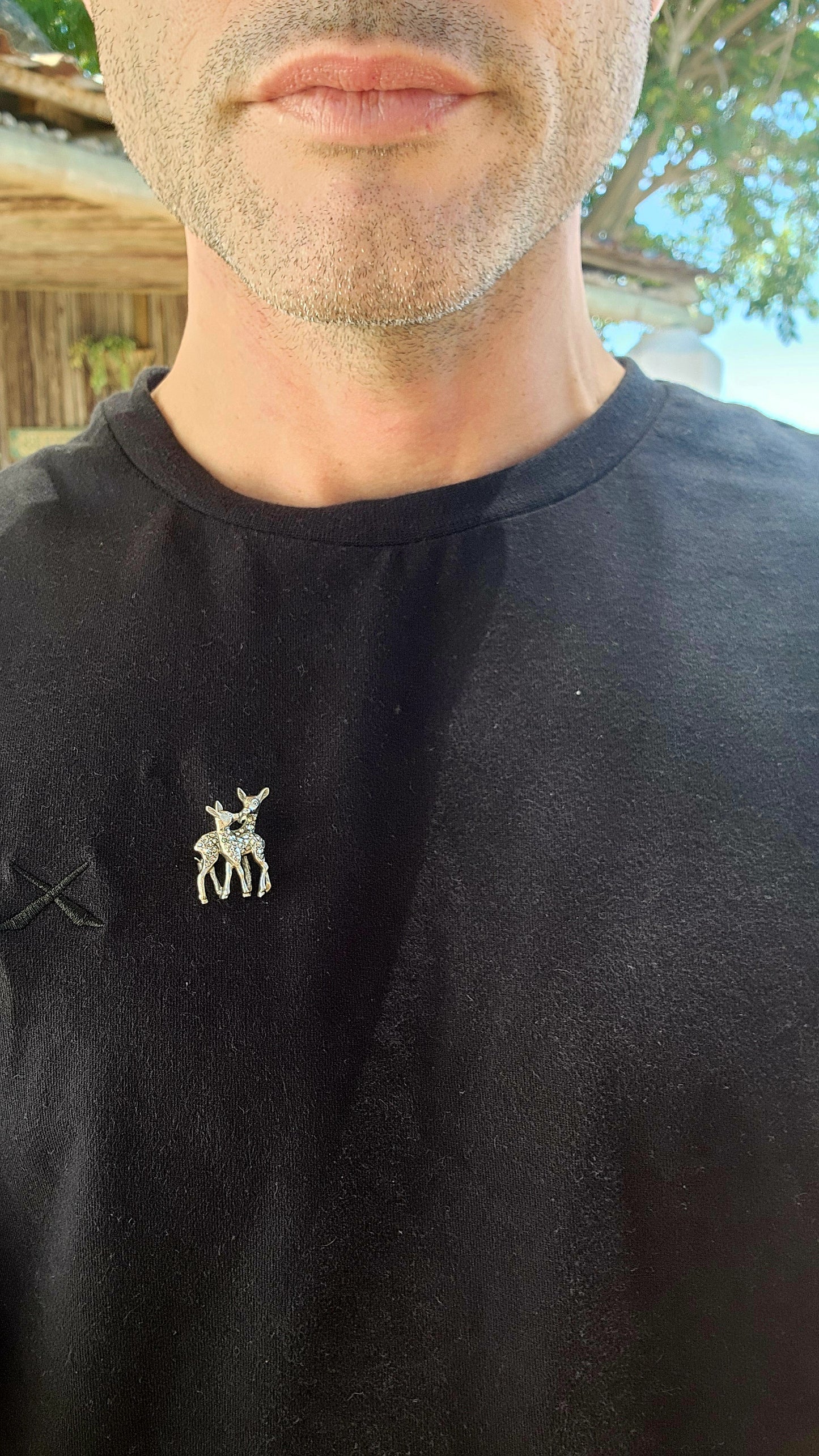 Imagine a tiny woodland scene captured in sterling silver, a moment of tenderness between a mother deer and her playful fawn, frozen in time with the elegance of the Art Deco era.