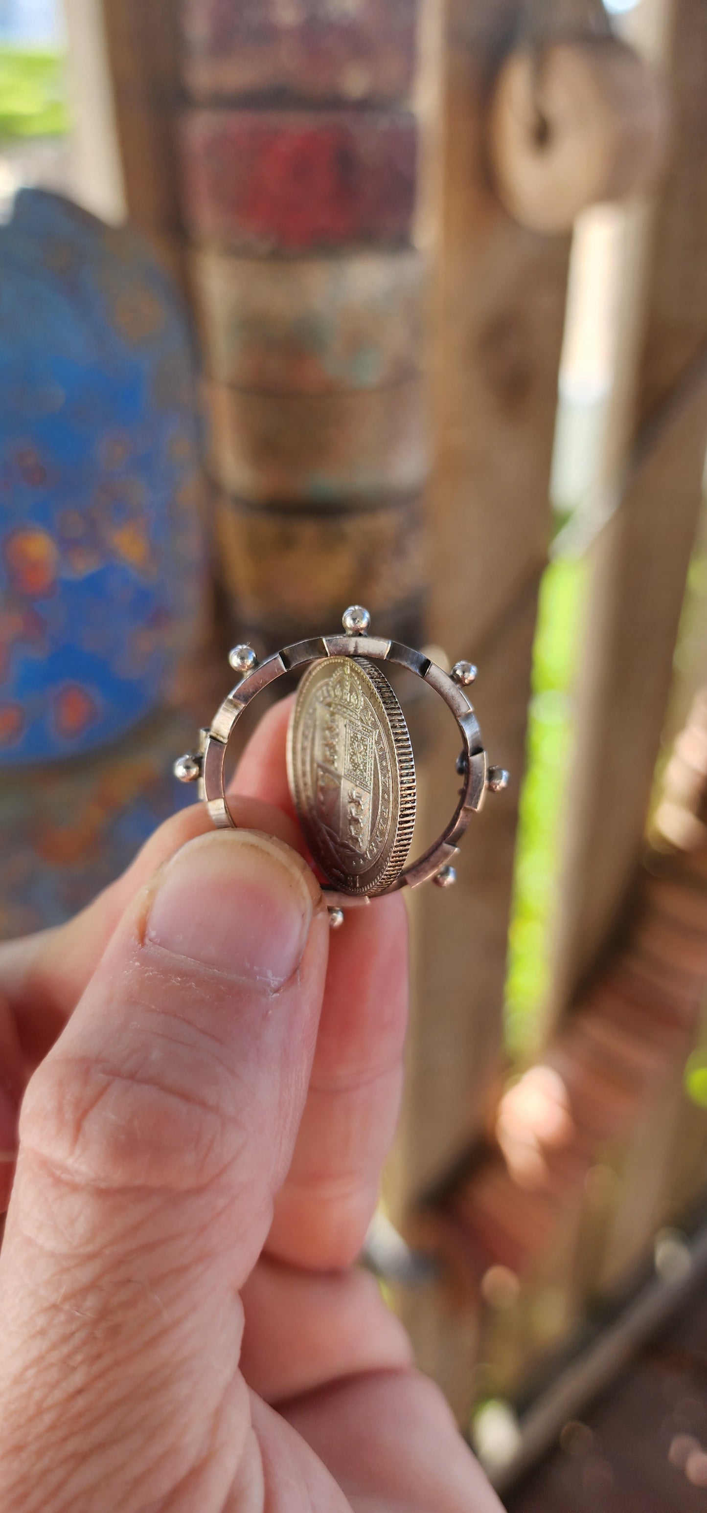 This exquisite antique Victorian-era brooch is crafted in sterling silver and features a 1887 Queen Victoria Jubilee Head silver shilling coin as its central element.