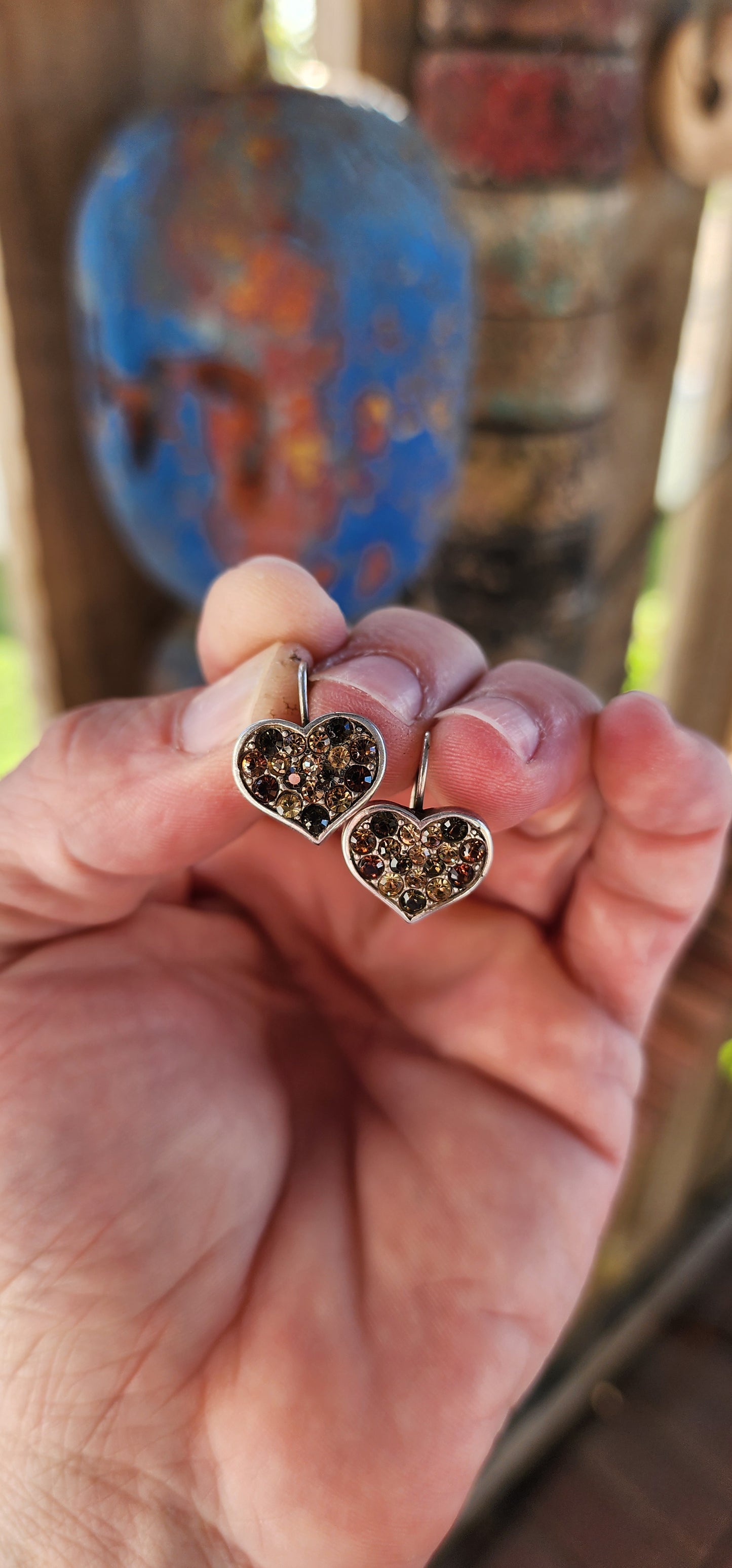 These Danon heart-shaped costume earrings are a little slice of romance with an earthy, fiery twist! Think of them as love letters from the sun, with their rich champagne, brown, and orange-hued rhinestones twinkling like autumn leaves.