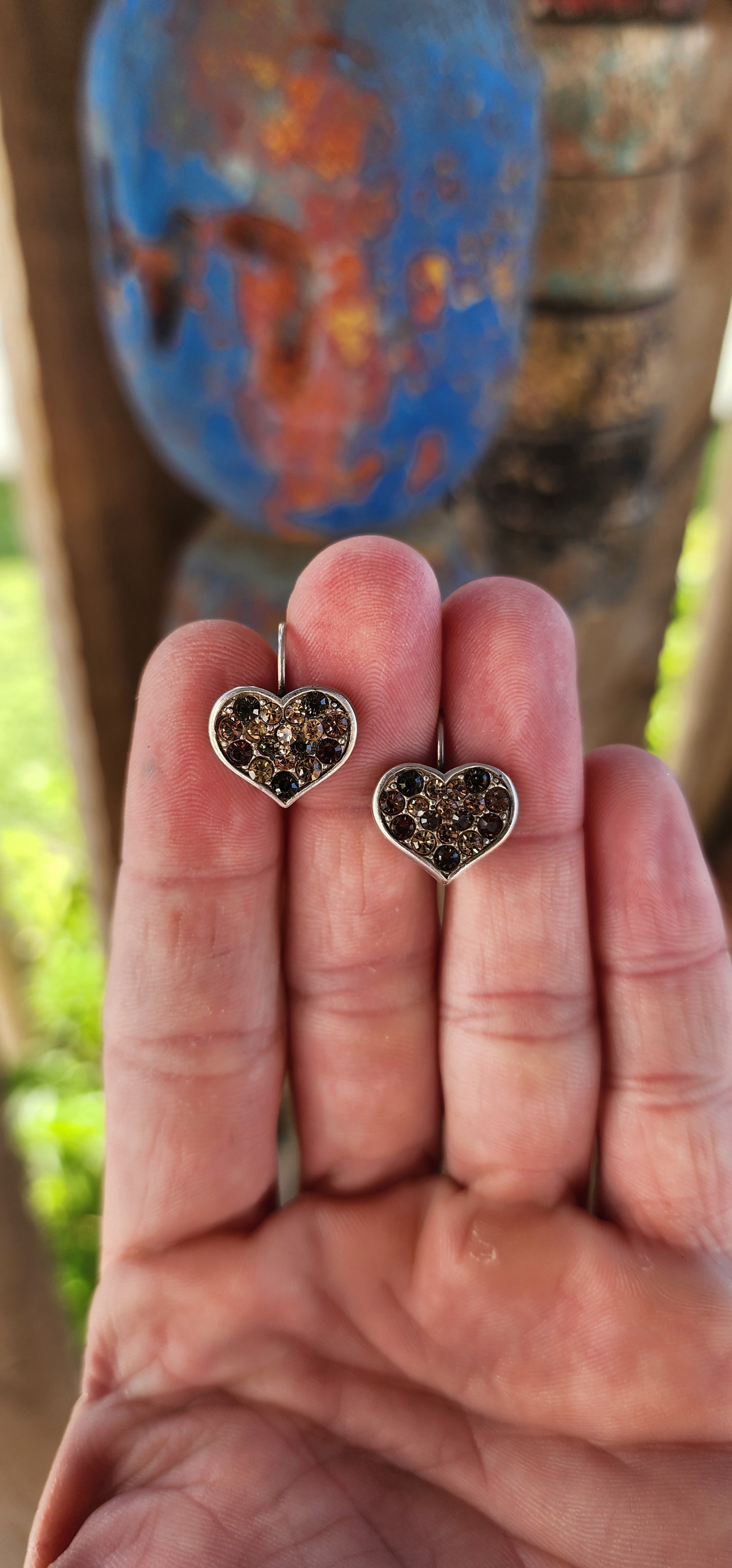 These Danon heart-shaped costume earrings are a little slice of romance with an earthy, fiery twist! Think of them as love letters from the sun, with their rich champagne, brown, and orange-hued rhinestones twinkling like autumn leaves.
