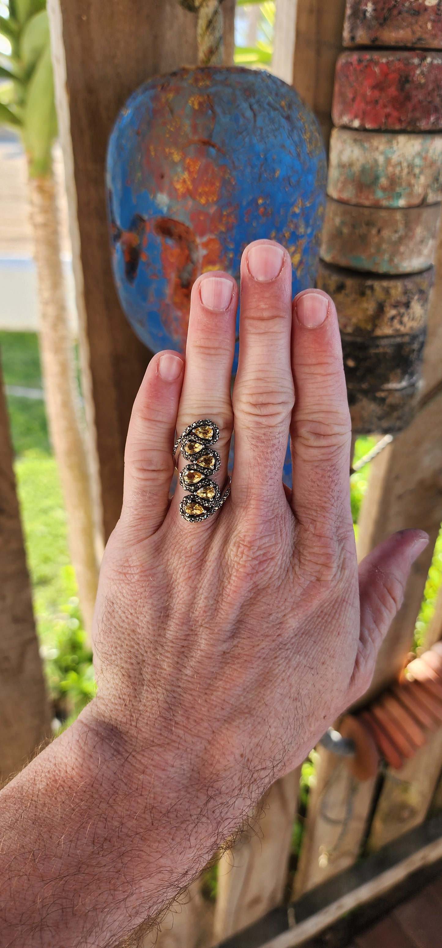 This sterling silver bypass style ring is an absolute showstopper, exuding a bold vintage aesthetic with its ornate craftsmanship and radiant gemstone arrangement.