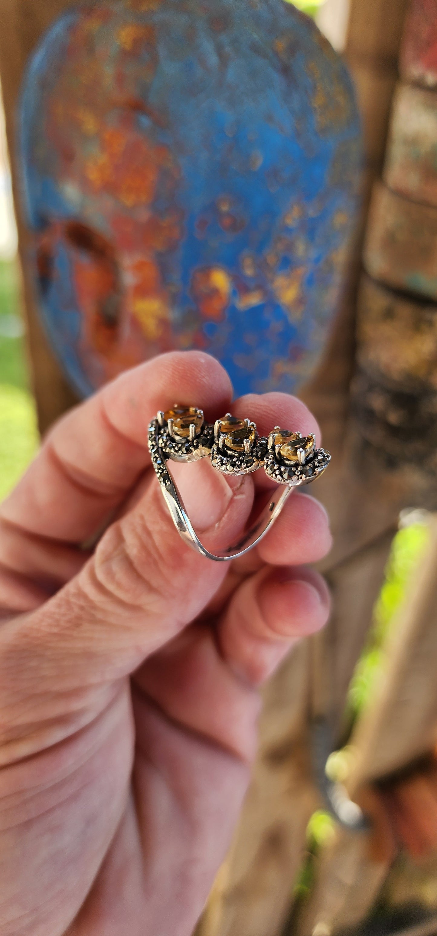This sterling silver bypass style ring is an absolute showstopper, exuding a bold vintage aesthetic with its ornate craftsmanship and radiant gemstone arrangement.
