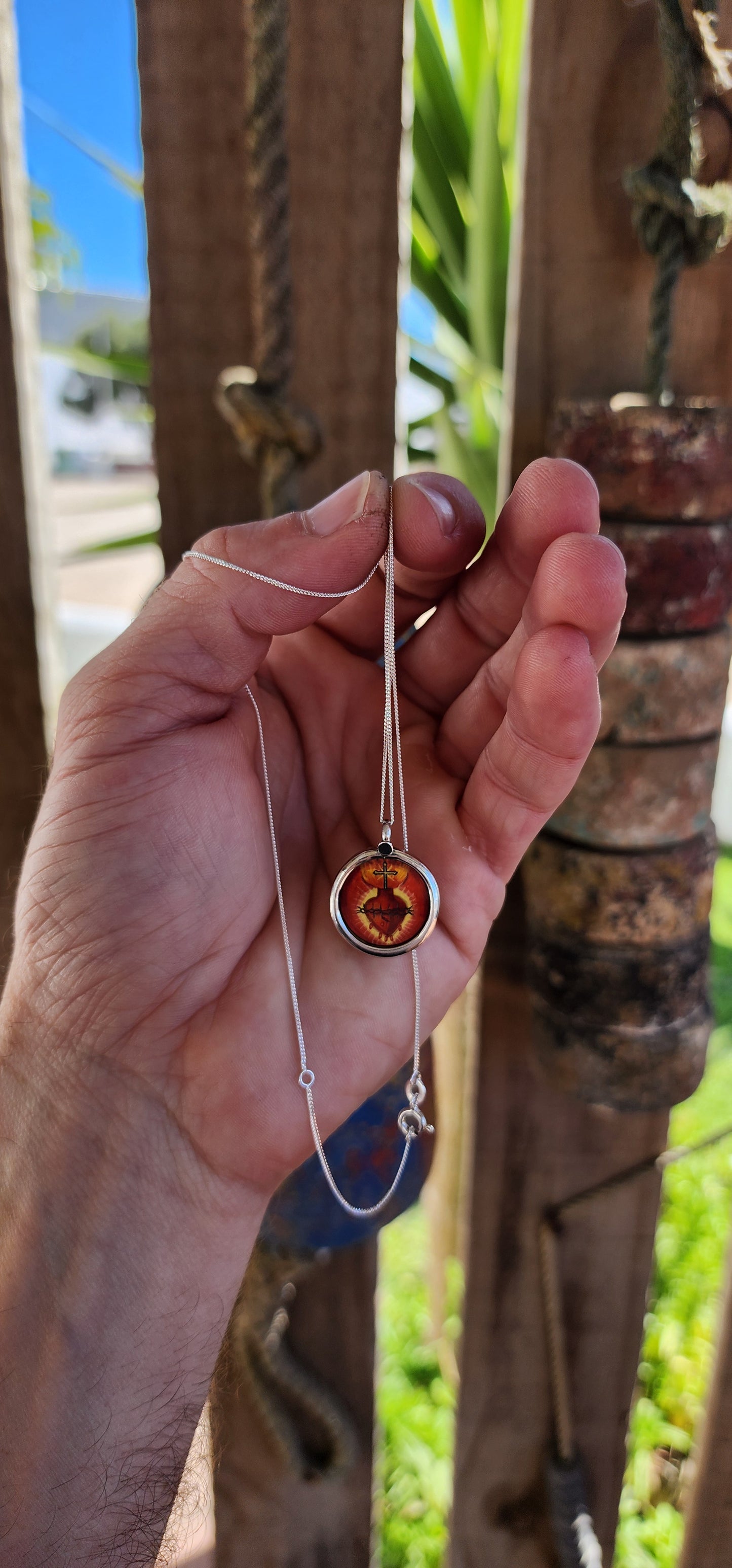 This miniature Sacred Heart hand-painted pendant is a true treasure—a little window into faith, history, and old-world craftsmanship, all wrapped up in sterling silver and glass!