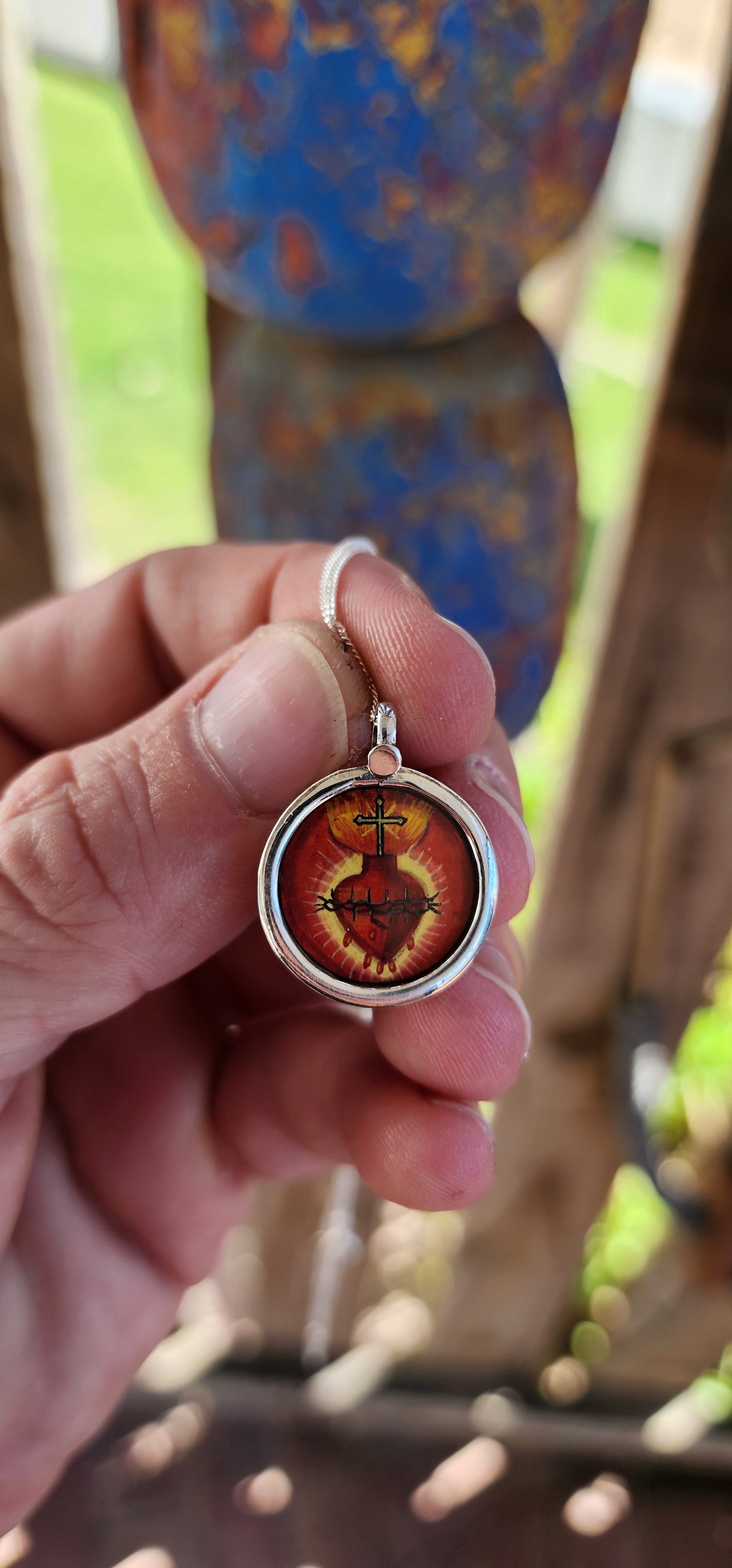 This miniature Sacred Heart hand-painted pendant is a true treasure—a little window into faith, history, and old-world craftsmanship, all wrapped up in sterling silver and glass!