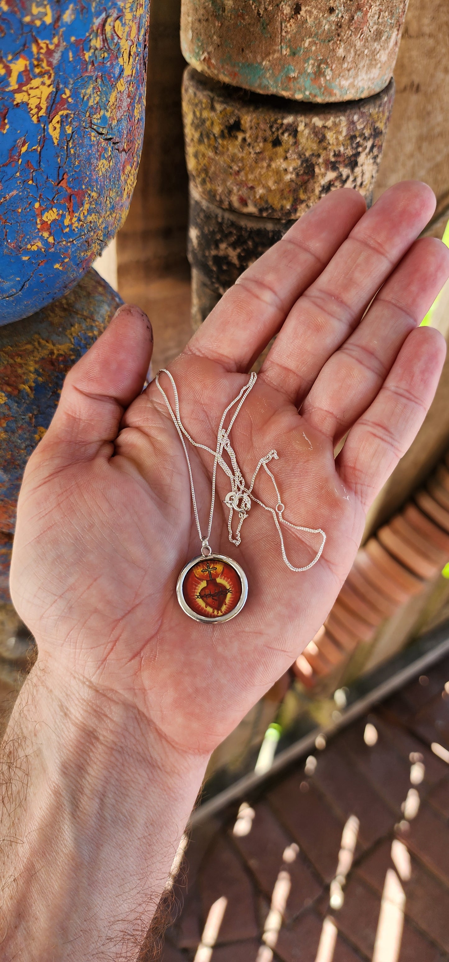 This miniature Sacred Heart hand-painted pendant is a true treasure—a little window into faith, history, and old-world craftsmanship, all wrapped up in sterling silver and glass!
