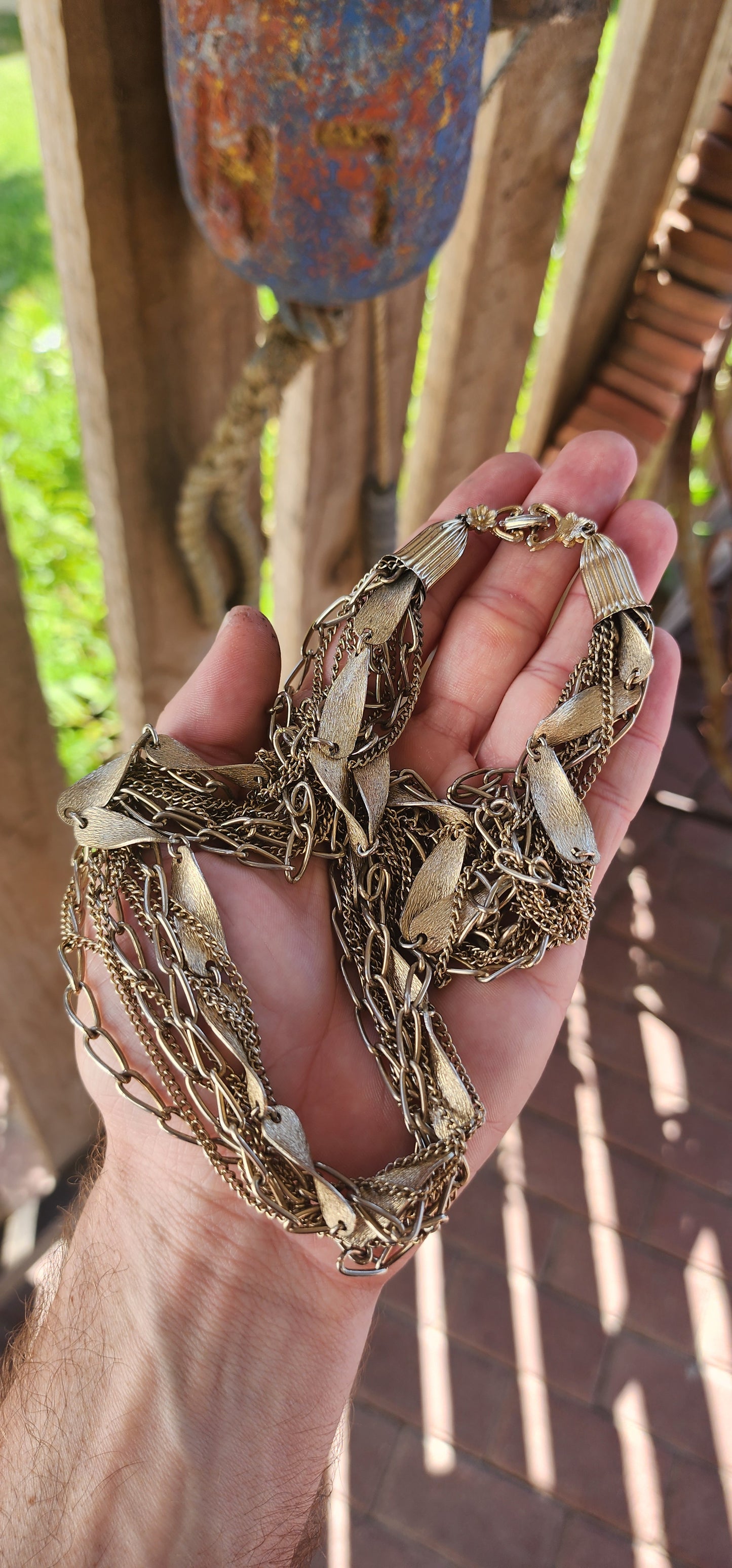 This vintage 1990s gold-plated multi-chain costume necklace is a stunning statement piece with an air of regal elegance and timeless charm.