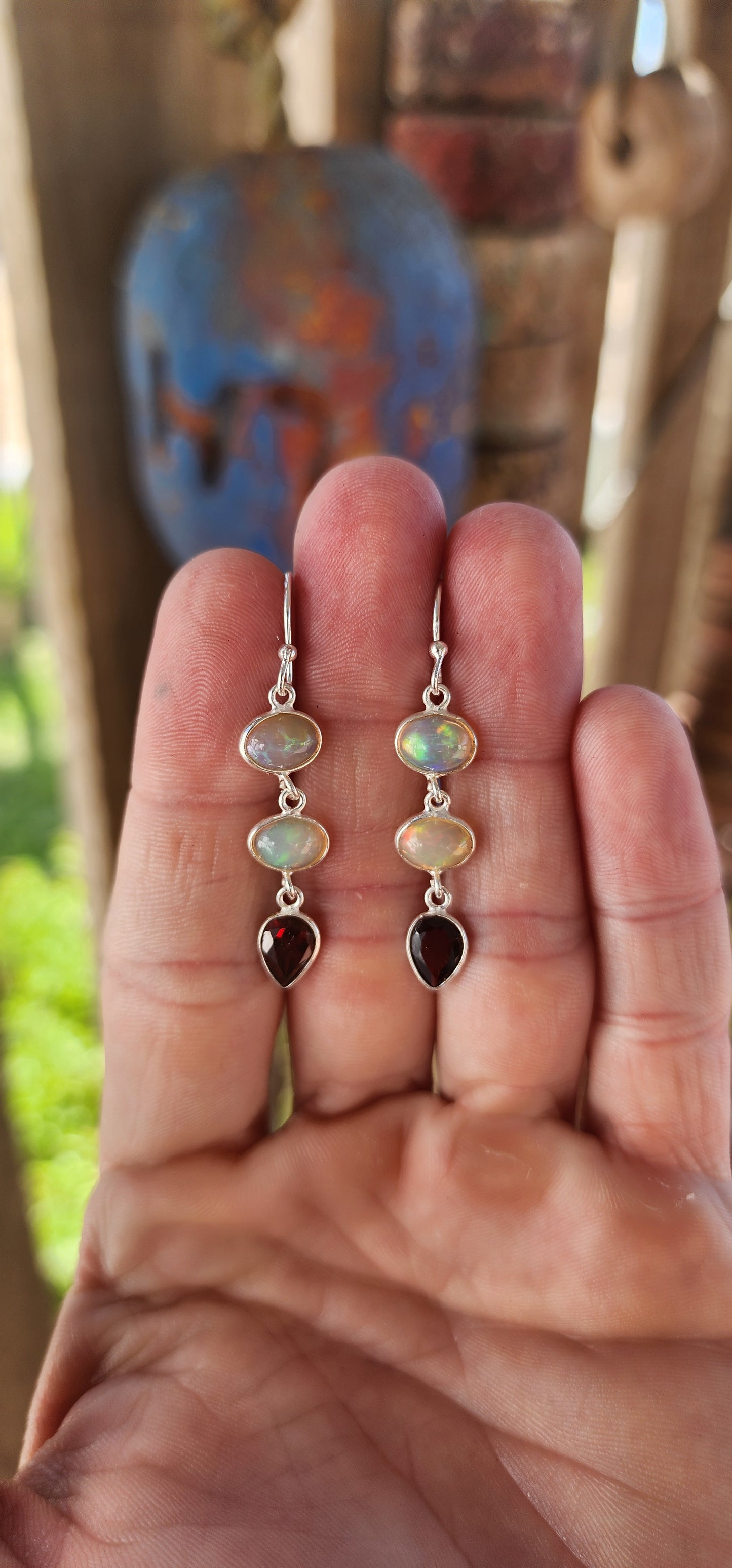 These exquisite sterling silver drop earrings are a mesmerizing fusion of fire and light, elegantly showcasing two birthstone options in a timeless, sophisticated design.
