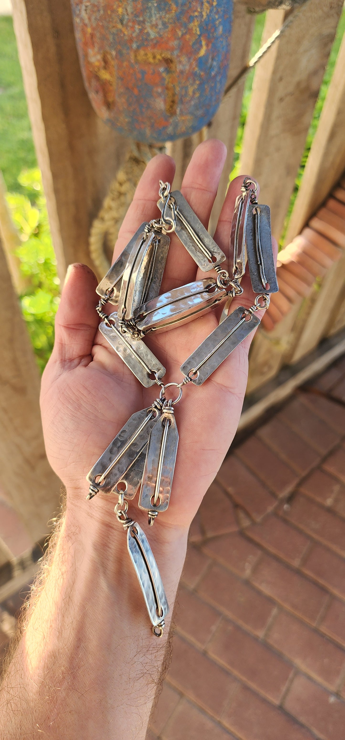 This striking vintage 1970s artisan-made modernist/brutalist silver-plated panel necklace is a bold statement of raw craftsmanship and industrial elegance.