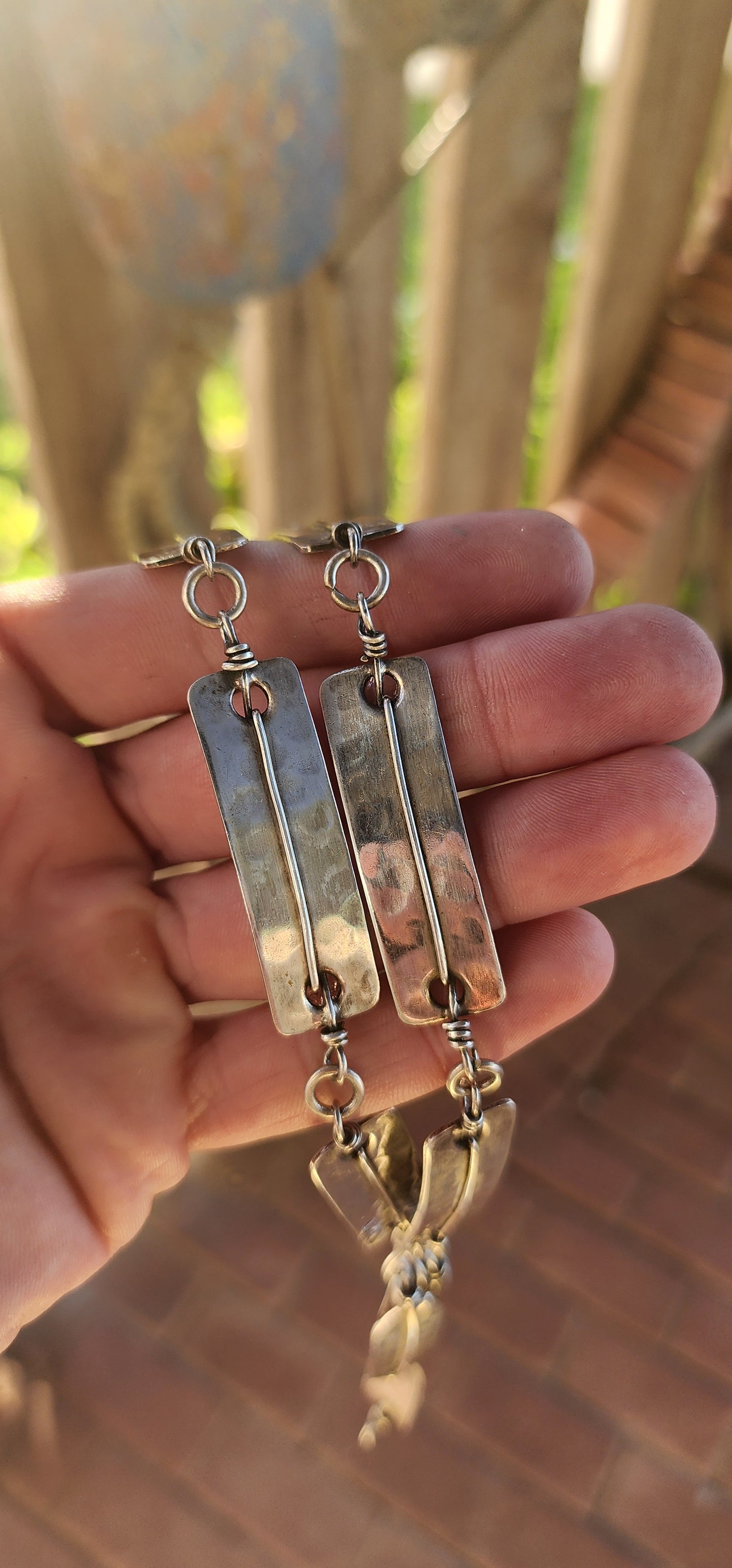 This striking vintage 1970s artisan-made modernist/brutalist silver-plated panel necklace is a bold statement of raw craftsmanship and industrial elegance.