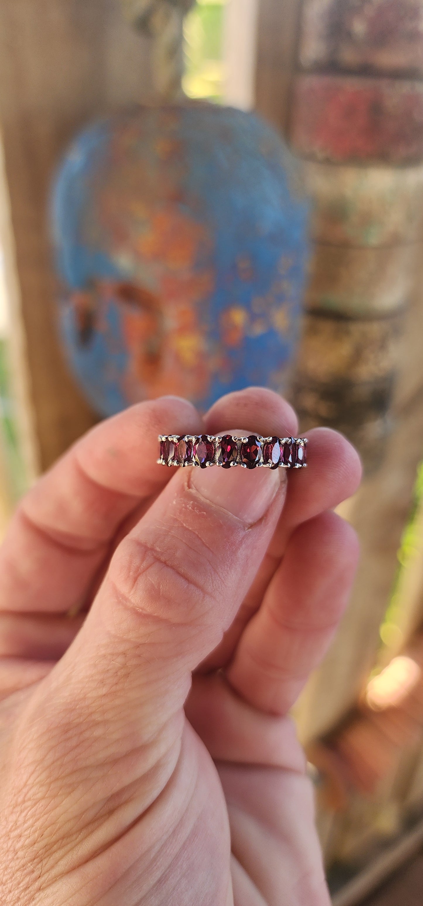 This sterling silver full eternity ring is a dazzling display of deep, rich purple rhodolite garnets, meticulously claw-set in an endless circle of brilliance.