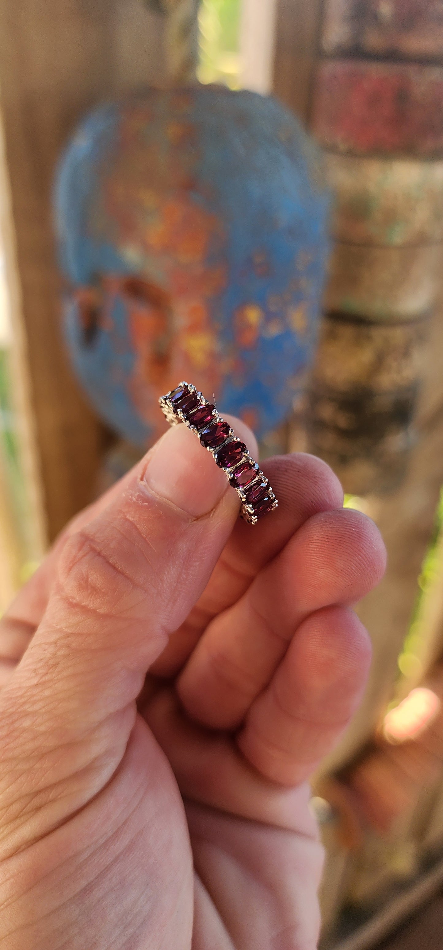 This sterling silver full eternity ring is a dazzling display of deep, rich purple rhodolite garnets, meticulously claw-set in an endless circle of brilliance.