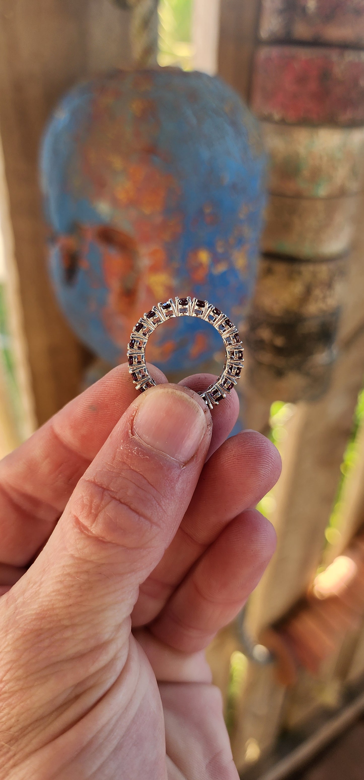 This sterling silver full eternity ring is a dazzling display of deep, rich purple rhodolite garnets, meticulously claw-set in an endless circle of brilliance.